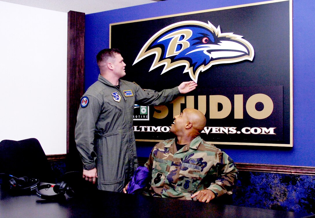 Staff Sgt. Daniel L. Lowry, left, and Staff Sgt. Gerald L. Ellis got a chance to sit in the Baltimore Raven television studio during a guided tour of the Ravens Football Camp facilities. Sergeant Lowry is assigned to the 316th Security Forces Squadron's Ravens. Sergeant Ellis is assigned to the 316 SFS as flight sergeant.. (U.S. Air Force/Bobby Jones)