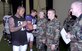 Willis McGahee, Baltimore Ravens running back, autographs a football for Senior Airman Christopher West during a break in their training camp session. Airman West is assigned to the 316 SFS as a Security Response Team leader.