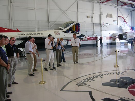 Civic leaders from Goldsboro, N.C. take pictures of the Thunderbirds crest located on the floor of Thunderbirds hangar at Nellis Air Force Base, Nev. More than 30 community leaders were able to learn more about the impressive base during a tour sponsored by the 916th Air Refueling Wing, Air Force Reserve and 4th Fighter Wing, Air Combat Command.