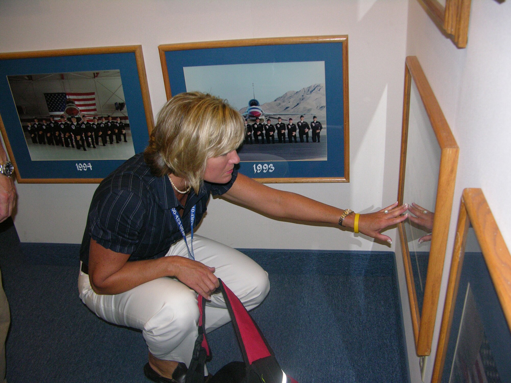 Joanna Thompson, a member of the Seymour Johnson Air Force Base Military Affairs Committee, looks intently a picture in the Thunderbirds Museum at Nellis Air Force Base, Nev. Ms. Thompson was part of a civic leader tour offered by the 916th Air Refueling Wing, Air Force Reserve Command and the 4th Fighter Wing, Air Combat Command, both located at the North Carolina base.