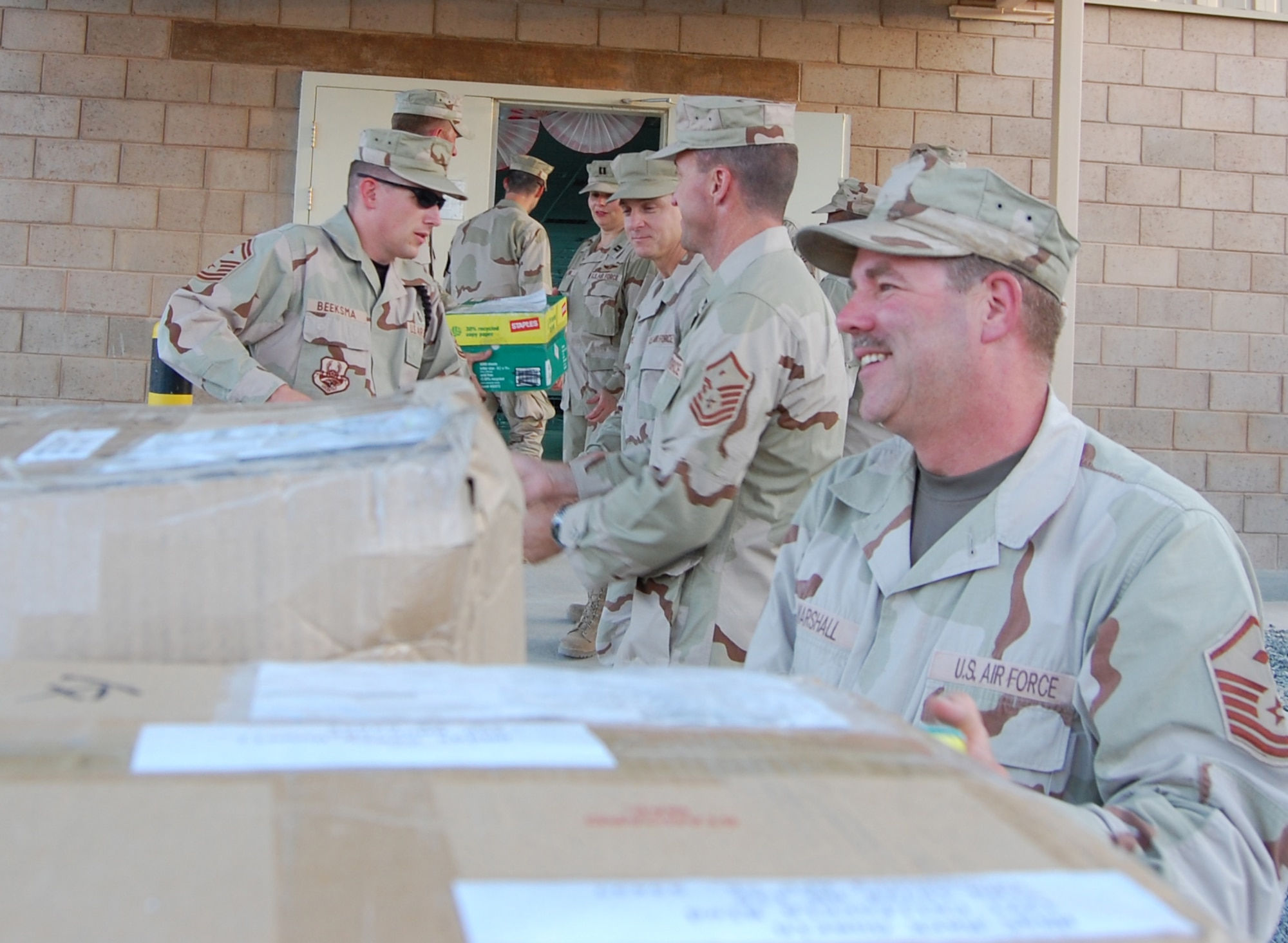 SOUTHWEST ASIA -- Deployed first sergeants receive the first Operation Warrior Comfort packages to arrive at the Contingency Air Staging Facility, or CSAF, which cares for sick and wounded Airmen and Soldiers transiting through on their way to Germany for care. The donations from Vandenberg will provide some of the wounded troops with clothes since most of them arrive to the CASF with nothing but the clothes on their backs. (U.S. Air Force courtesy photo)
