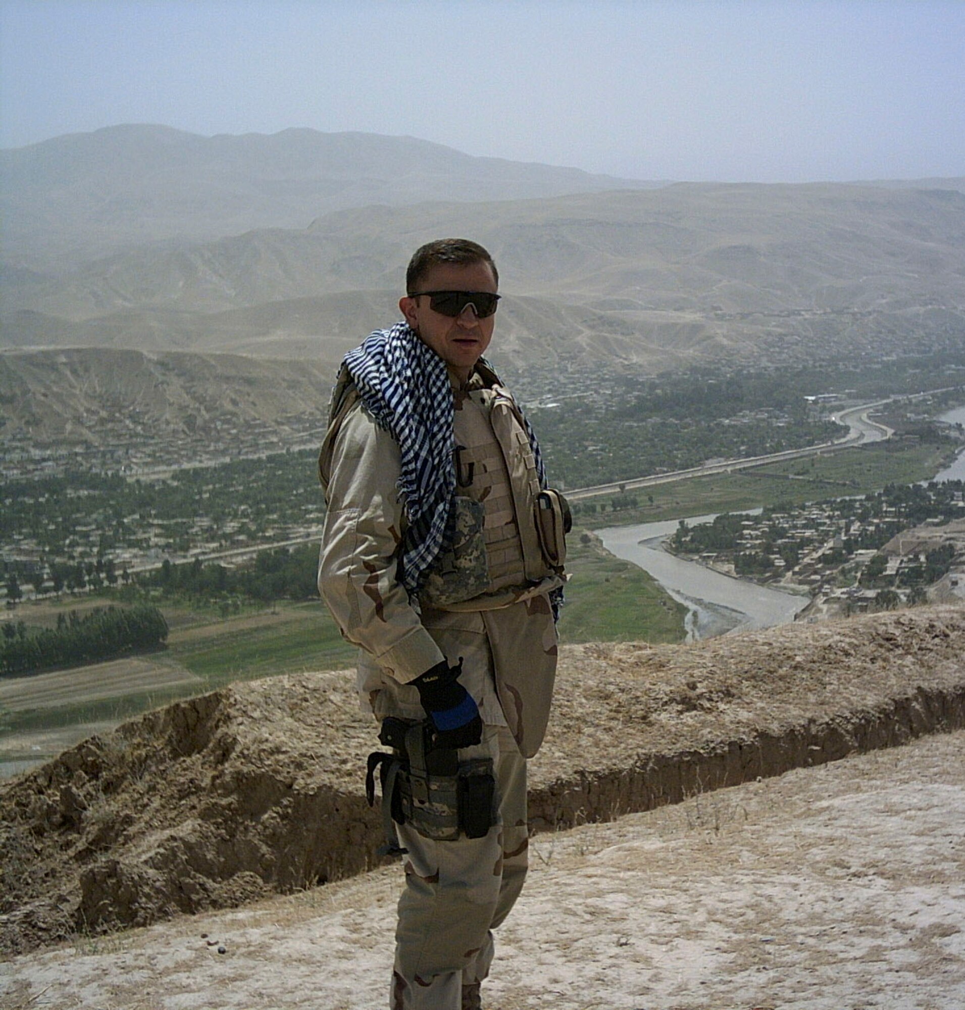 Atop a former Soviet minefield in Afghanistan stands Maj. Homer Nesmith, a T-6 instructor pilot from Vance Air Force Base's 5th Flying Training Squadron. Remnant mines, trenches and scrap materials are still part of the landscape. (Courtesy photo)