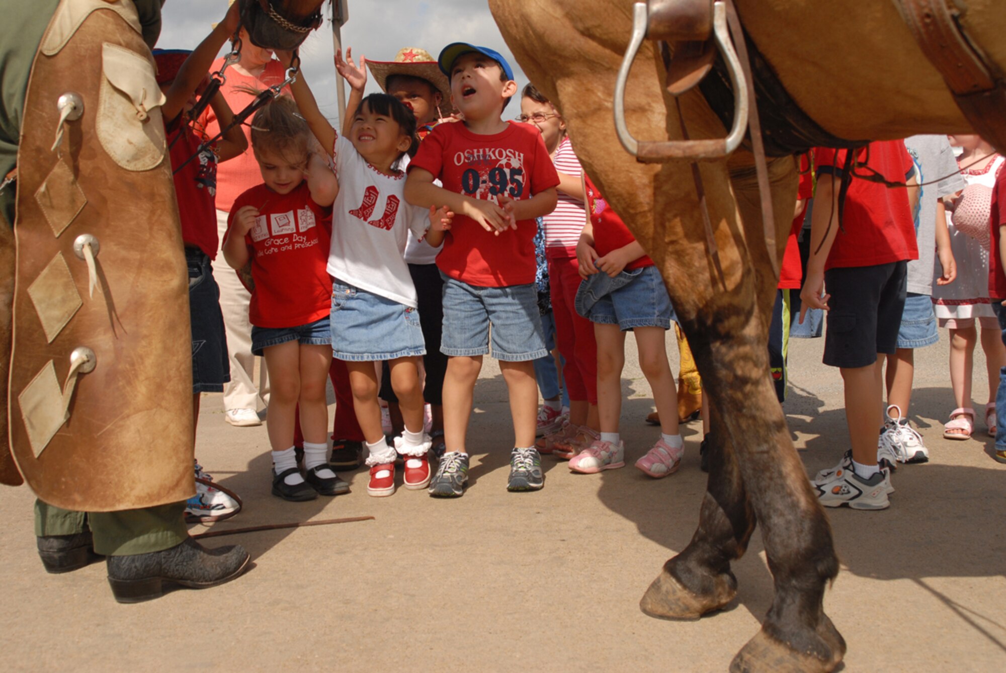 Col. David Allvin, 97th Air Mobility Wing commander, greets children during the Altus Air Force Base cattle drive Aug. 23, 2007 . (U.S. Air Force photo/Airman First Class Rebecca Talley)