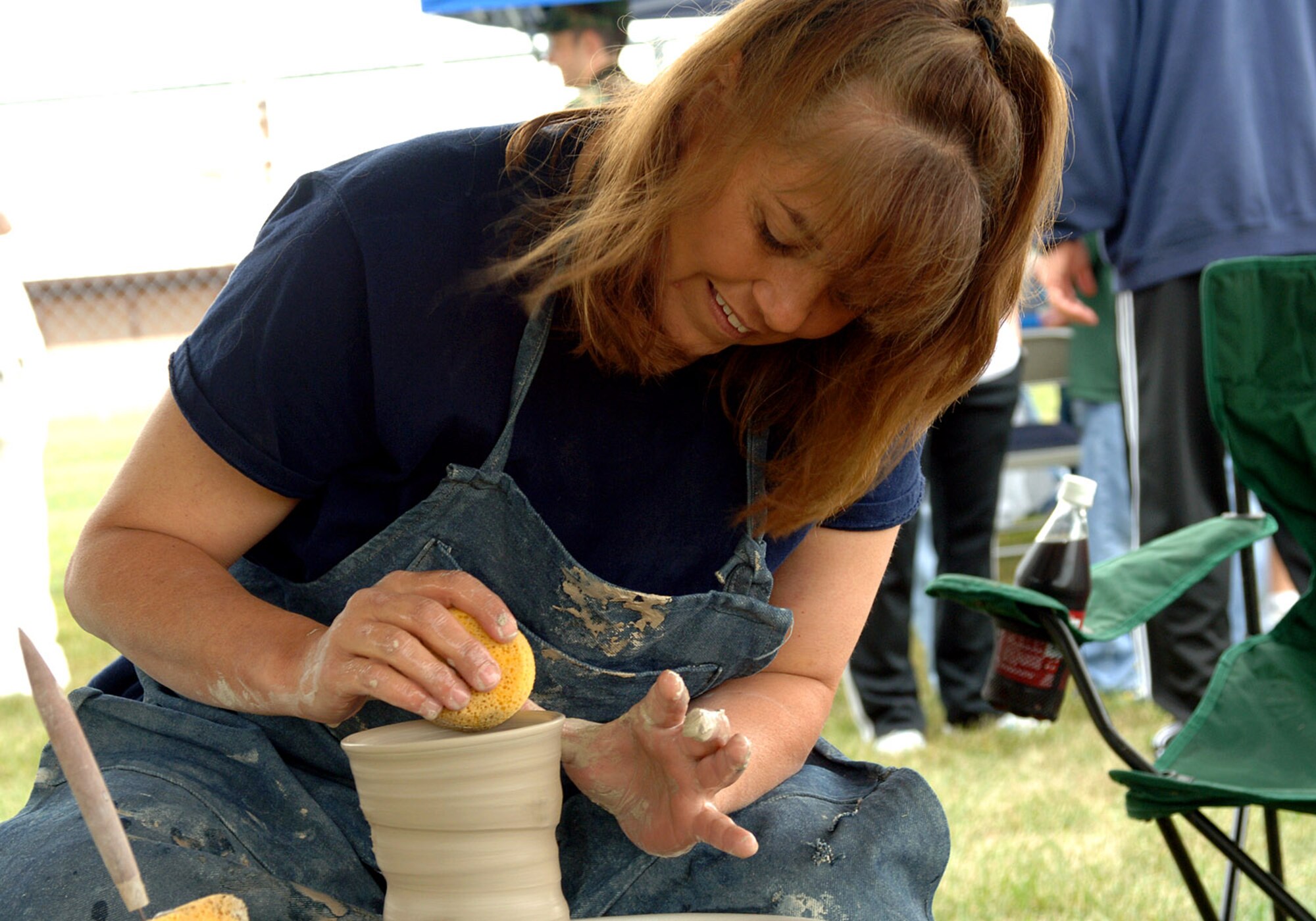 Debbie Sumner demonstrates the delicate hobby of pottery making. Pottery was one of many demonstration and vendor booths set up during Summer Bash. (U.S. Air Force photo/Senior Airman SerMae Lampkin)
