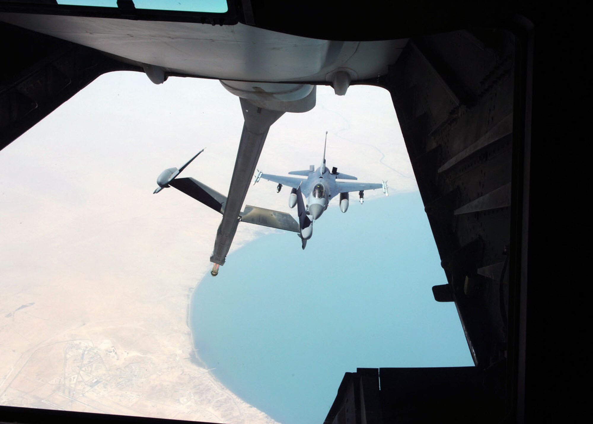 An F-16 Fighting Falcon eases up to the refueling boom of a KC-10 Extender during an Operation Iraqi Freedom mission.  F-16s provide shows of force to enemy troops and provide overwatch for coalition troops on the ground in Iraq.  (U.S. Air Force photo/Airman 1st Class Matt Cook)