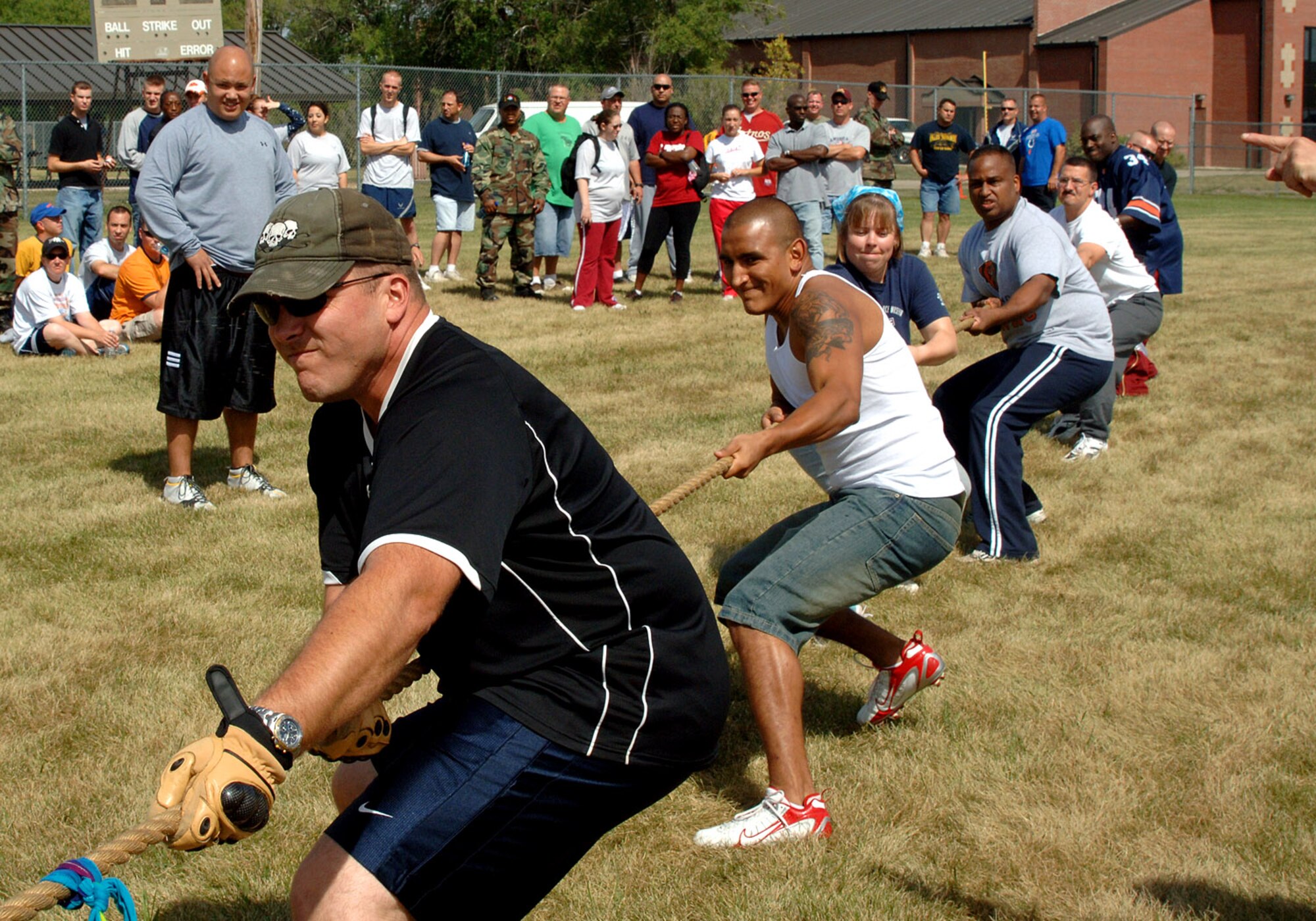 The 319th Communication Squadron's tug-of-war team struggles to pull the flag over the line while competing during this year's Summer Bash. In the end, the comm. team was only defeating by the 319th Civil Engineer Squadron, winning second place. (U.S. Air Force photo/Senior Airman SerMae Lampkin)