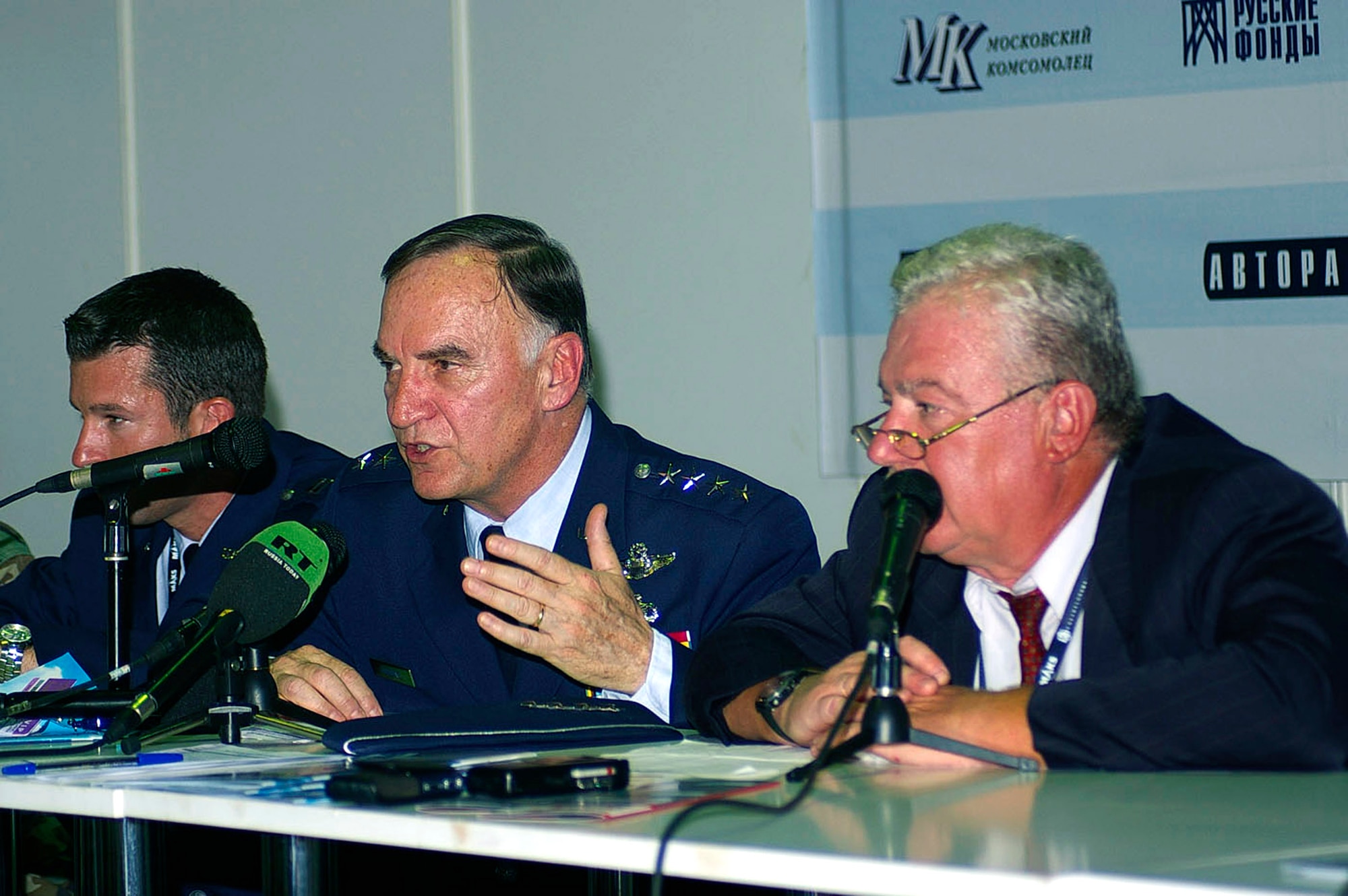 Gen. William T. Hobbins (center) talks to media during a press conference Aug. 21 at the Moscow International Air Show at Ramenskoye Airfield in Zhukovsky, Russia.  Capt. John Morash (left) helps deal with queries as Victor Polishnuk prepares to translate questions and answers. (U.S. Air Force photo/Karen Abeyasekere)