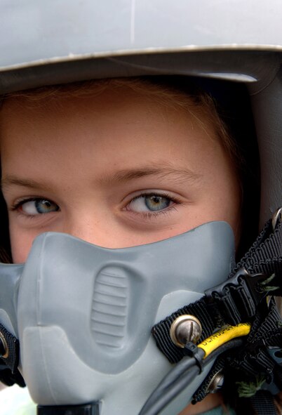 Veronica Morrier, 8, from Concord, N.H., tries on a fighter pilot helmet during an Air Force pilot's life support survival equipment display by members of Pease Air National Guard Base from New Hampshire Aug. 21 in Concord, N.H. The Christa McAuliffe Planetarium hosted the Air Force New England Science Day, which provided children and adults hands-on displays of Air Force equipment, a model rocket launch demonstration, an F-16 Fighting Falcon static display, and "Do Something Amazing" display trailers. (U.S. Air Force photo/Staff Sgt. Bennie J. Davis III)
