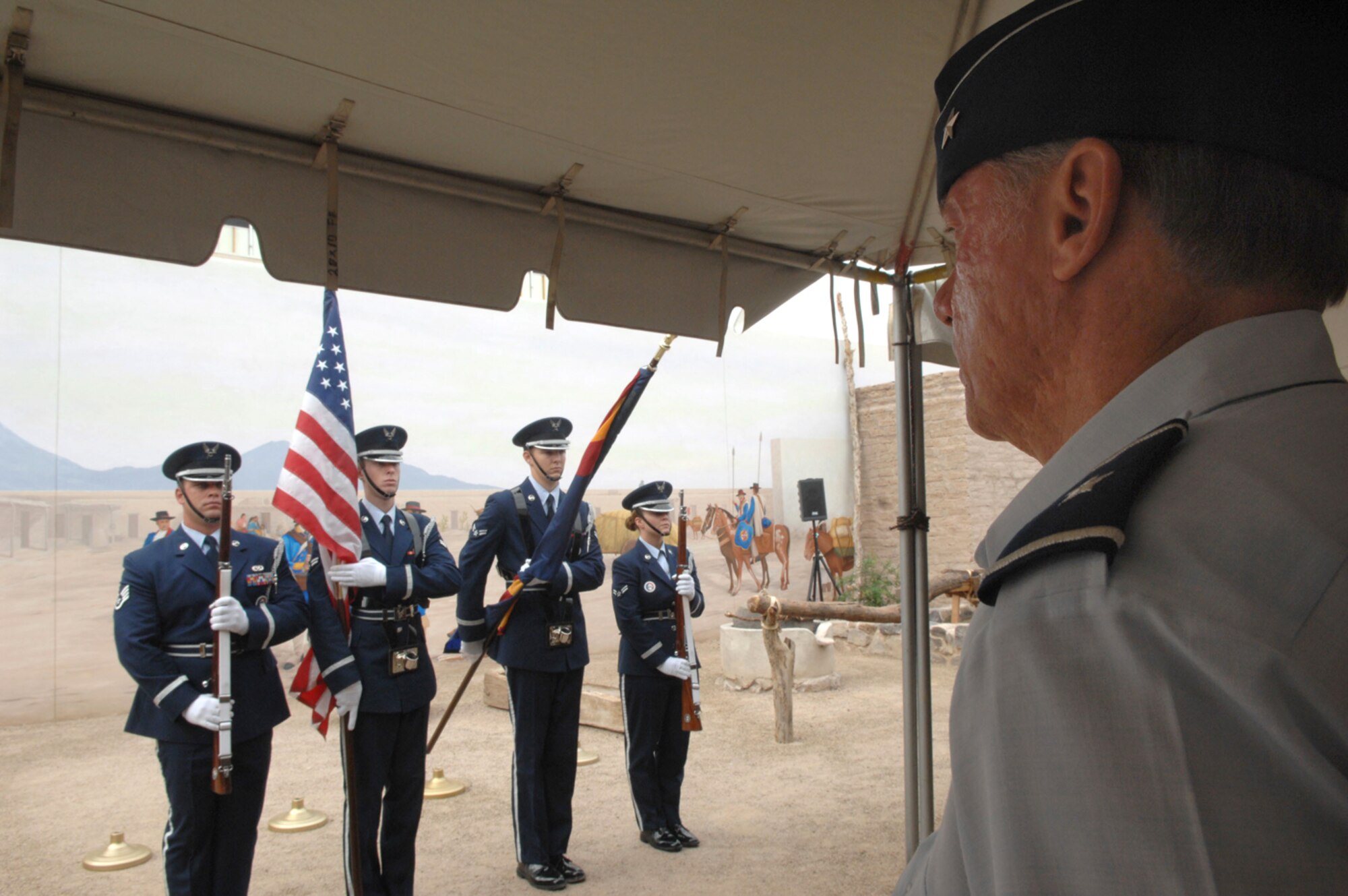 Brig. Gen. Robert Bartlett, mobilization assistant to the 12th Air Force commander, looks on as the Davis-Monthan Air Force Base honor guard presents the American flag during a ceremony Aug. 20 at Presidio San Agustin de Tucson Courtyard. The flag ceremony was one of several events held in celebration of Tucson's 232nd birthday. (U.S. Air Force photo/Airman 1st Class Alesia D. Goosic)
