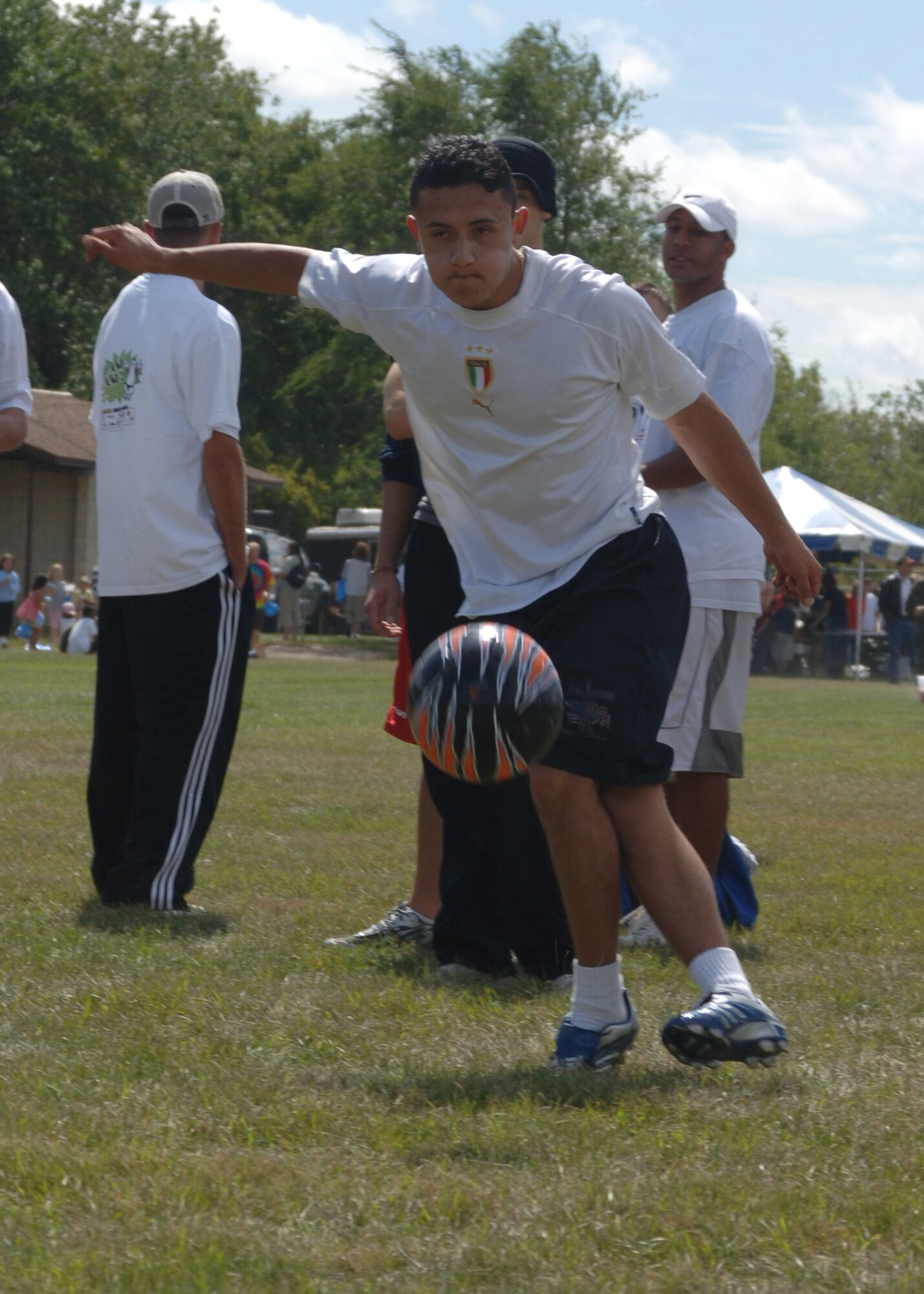 GRAND FORKS AFB, ND-- Airman Diego Cardona, 319th Logistics Readiness Squadron, boots a soccer ball while competing in the soccer kick contest during the 2007 Summer Bash here. Summer Bash is the wing's annual picnic, celebrating summer, sports and family. (USAF Photo/Staff Sgt Suellyn Nuckolls)