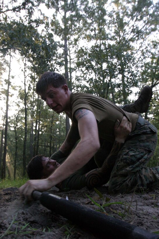 A Marine reaches for a weapon while grappling another Marine during Marine Special Operations Advisor Group?s 12-day light-infantry tactics training package at Mike Bravo training area here, from Aug. 20 until Friday. The training is part of U.S. Marine Corps Forces, Special Operations Command?s continuous preparation for Foreign Internal Defense missions. Forty Marines with MSOAG?s six-month student pipeline conducted day and night raid operations, combat patrols, ambushes, assaults and a combination of movement and live-fire exercises. They also learned various knife and baton combat techniques to help them in close-combat situations.