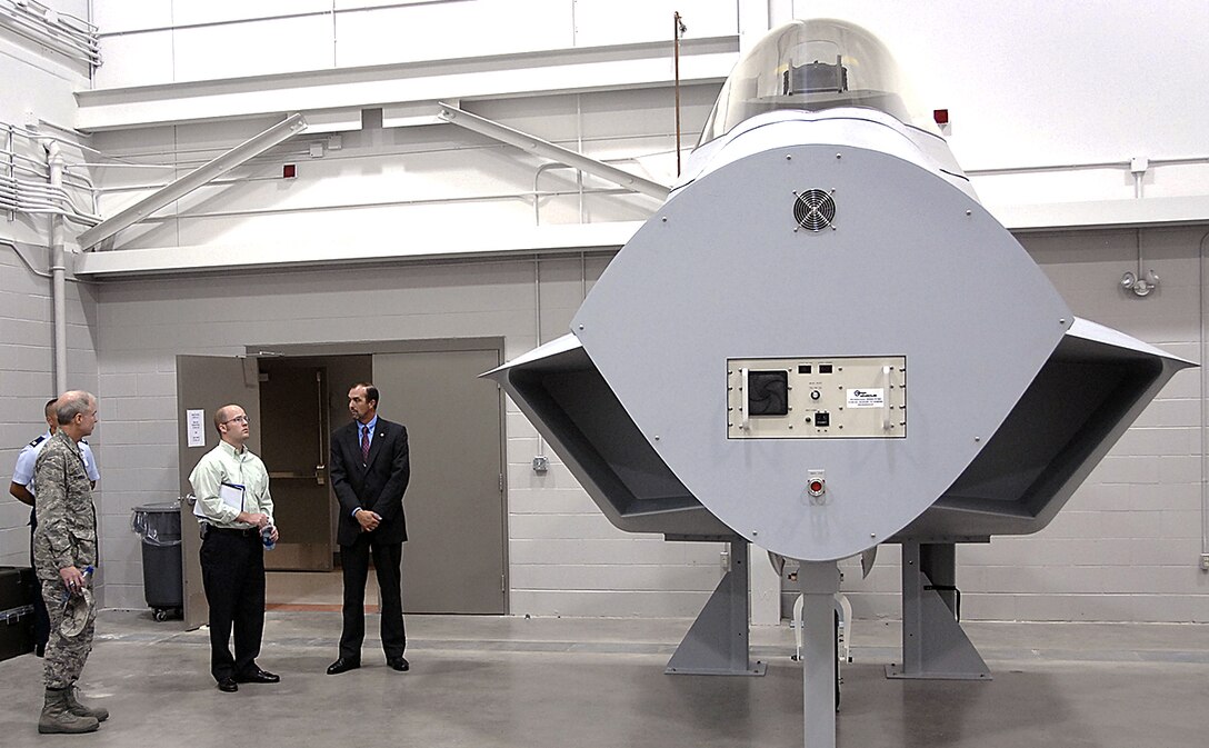 Ryan Crumpler, staffing aide to Congressman Mac Thornberry, R-Texas, checks out an F-22 mockup in Bldg. 1065 as part of his Sheppard orientation tour. From left: Brig. Gen. Richard Devereaux, 82nd Training Wing commander; Mr. Crumpler; and Donnie Manos, F-22 operations scheduler. (U.S. Air Force photo/Harry Tonemah)