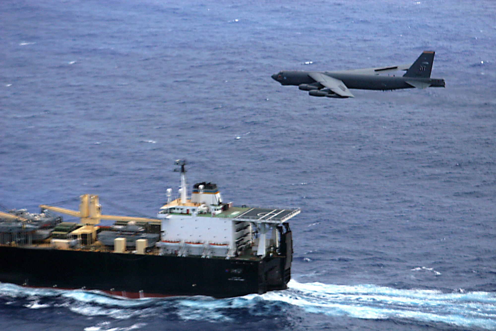 A 2nd Bomb Wing B-52H Stratofortress flies over the UNSN 2nd Lt John P Bobo, a maritime pre-positioning ship, during a maritime intercept training mission, Aug 24. (U.S. Air Force photo/Lt. Col. Ricardo Beruvides)
