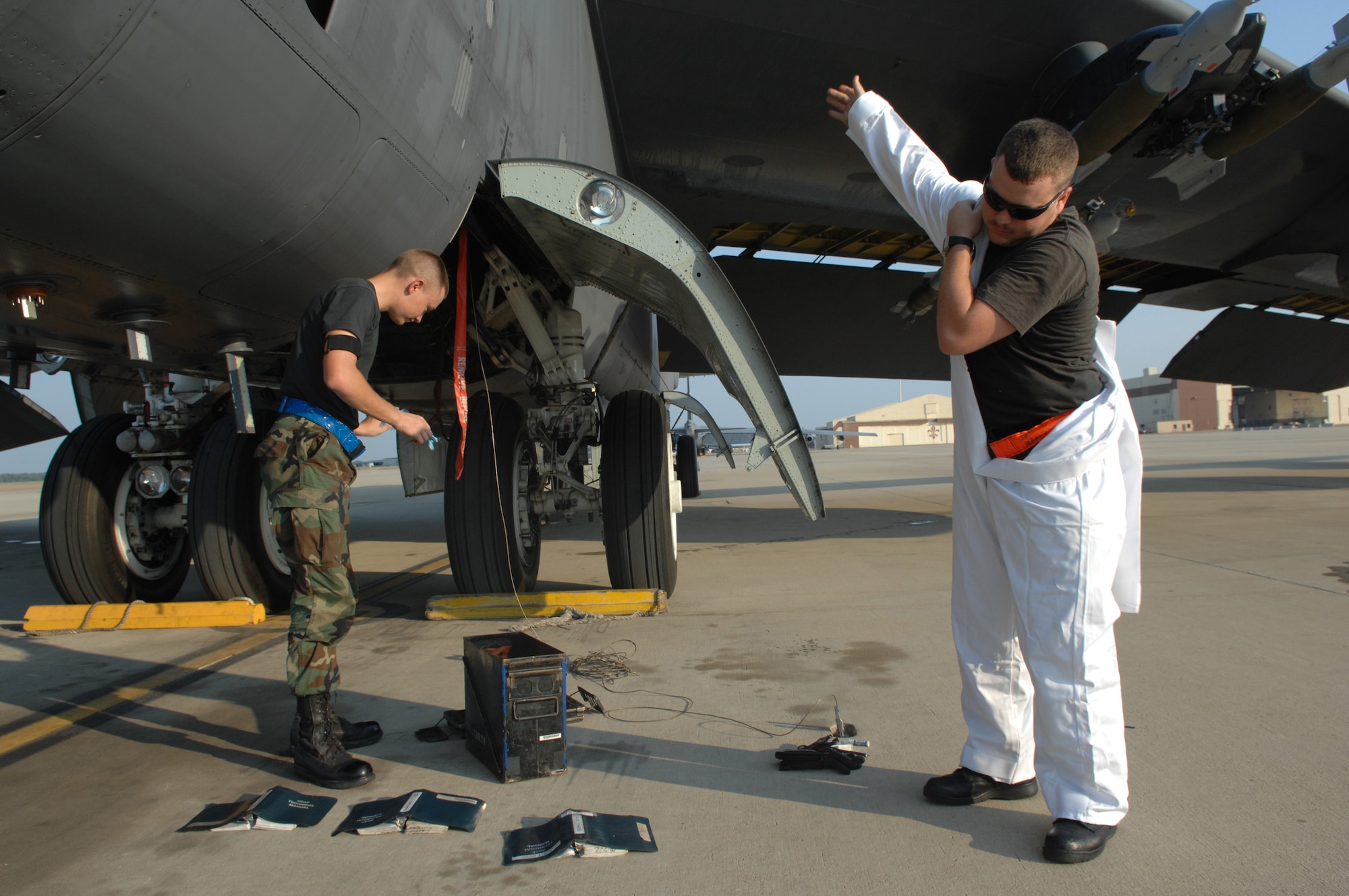 Airman 1st Class Jason Edwards and Senior Airman William Braswell put on protective gear prior to conducting a through flight inspection on a 2d Bomb Wing B-52H Stratofortress.  Both are 2nd Aircraft Maintenance Squadron crew chiefs. The aircraft had just returned from flying a maritime intercept training mission, Aug 24. (U.S. Air Force photo/Tech. Sgt. Laura Smith)
