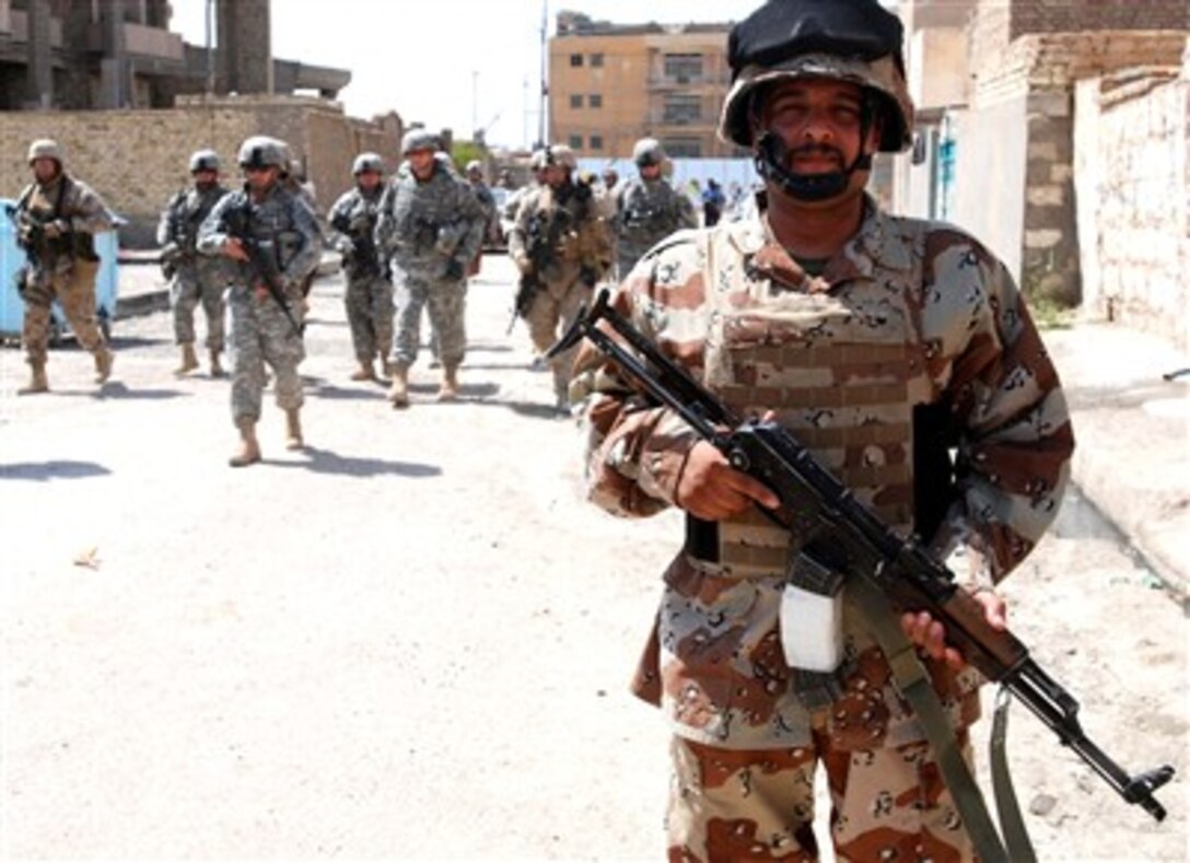 An Iraqi army soldier leads a patrol of American troops and Iraqi security forces in Ramadi, Iraq, Aug. 22, 2007. 