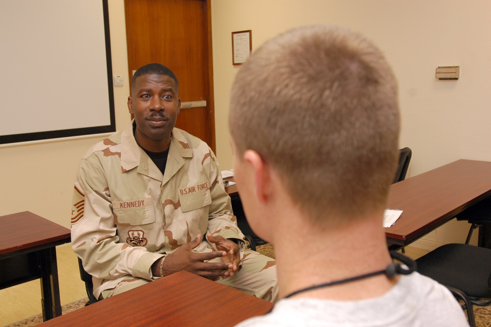 Master Sgt. John F. Kennedy (left) discusses reintegration with an Airman during one of the Airman Readiness Center’s Reintegration Briefings held twice daily. Each class is tailored to the needs of those in it, because each person has a different reintegration situation. (U.S. Air Force photo by Senior Airman Clark Staehle)
