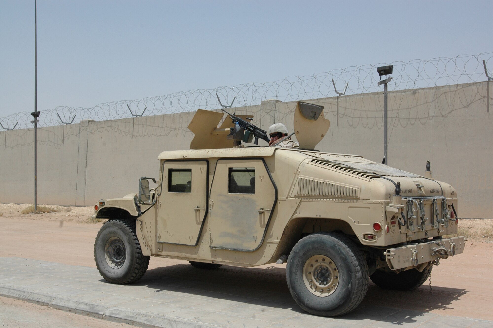 A security forces Airman with the 64th Air Expeditionary Group stands watch over fellow Airmen as they infiltrate a building during an exercise Aug. 20.  (U.S. Air Force photo by Capt. Teresa Sullivan)