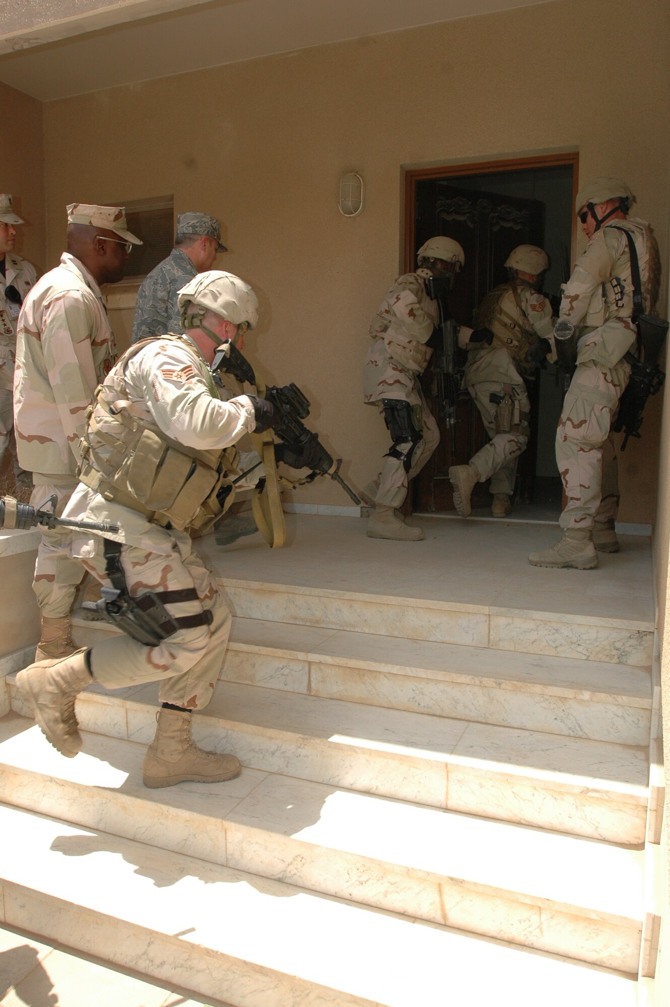 Security forces Airmen with the 64th Air Expeditionary Group demonstrate how to infiltrate a house in an urban environment at a foward deployed location. (photo by Staff Sgt. Evangeline Guidry)