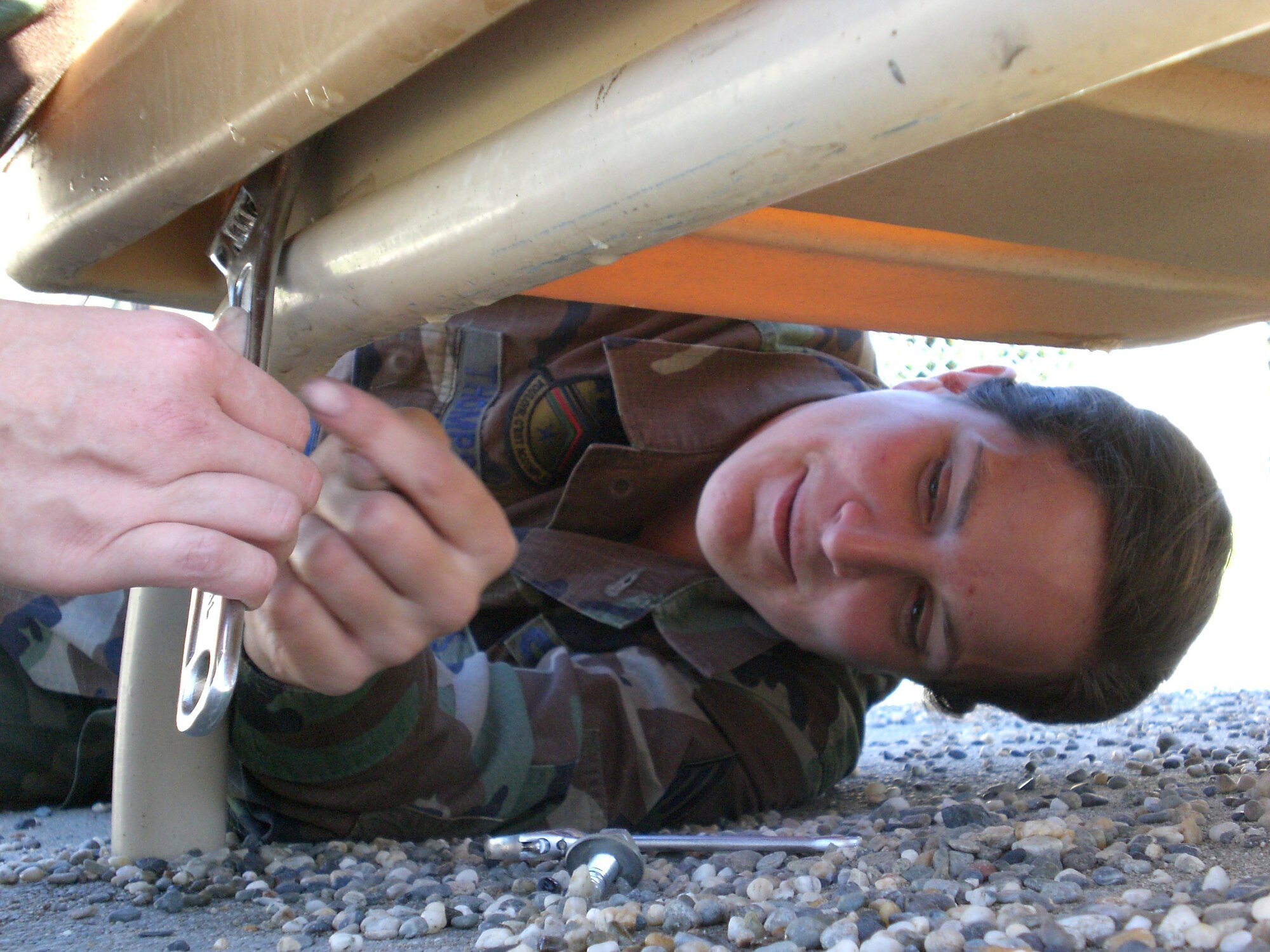 EIELSON AIR FORCE BASE, Alaska--Senior Airman Jaclyn Thompson, 354th Maintenance Squadron, disassembles a slide Aug. 23 from the Eielson AFB child development center playground. More than 15 members of the Eielson community volunteered their time to remove the antiquated playground equipment, which the 354th Force Support Squadron is replacing in September. The CDC provides  childcare to working Air Force parents with children 6 weeks to 5 years old. (U.S. Air Force photo by Tech. Sgt. Grace Lamoureux)
