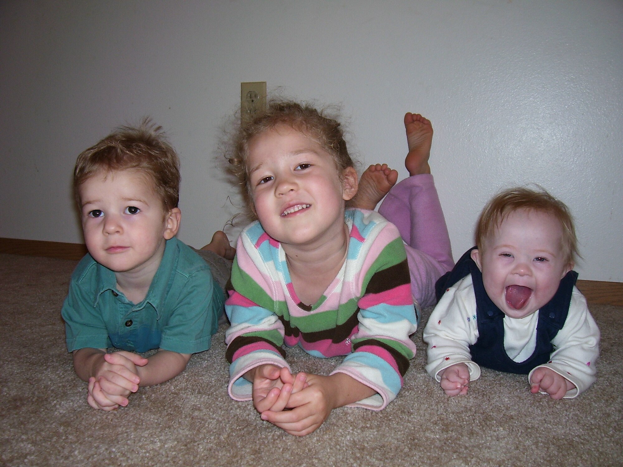 EIELSON AIR FORCE BASE, Alaska--Two-year old Camden, 4-year old Reagan and 8-month old Kalleigh Young, children of Judi and Tech. Sgt. Dan Young, 354th Maintenance Squadron, pose for a picture together. Kalliegh will be one of 215 people with Down syndrome to be featured in the big screen in Time Square on Sept. 30, 2007.  The video will kick off the National Down Syndrome Society's 2007 buddy walk, and National Down Syndrome Awareness Month. (courtesy photo)