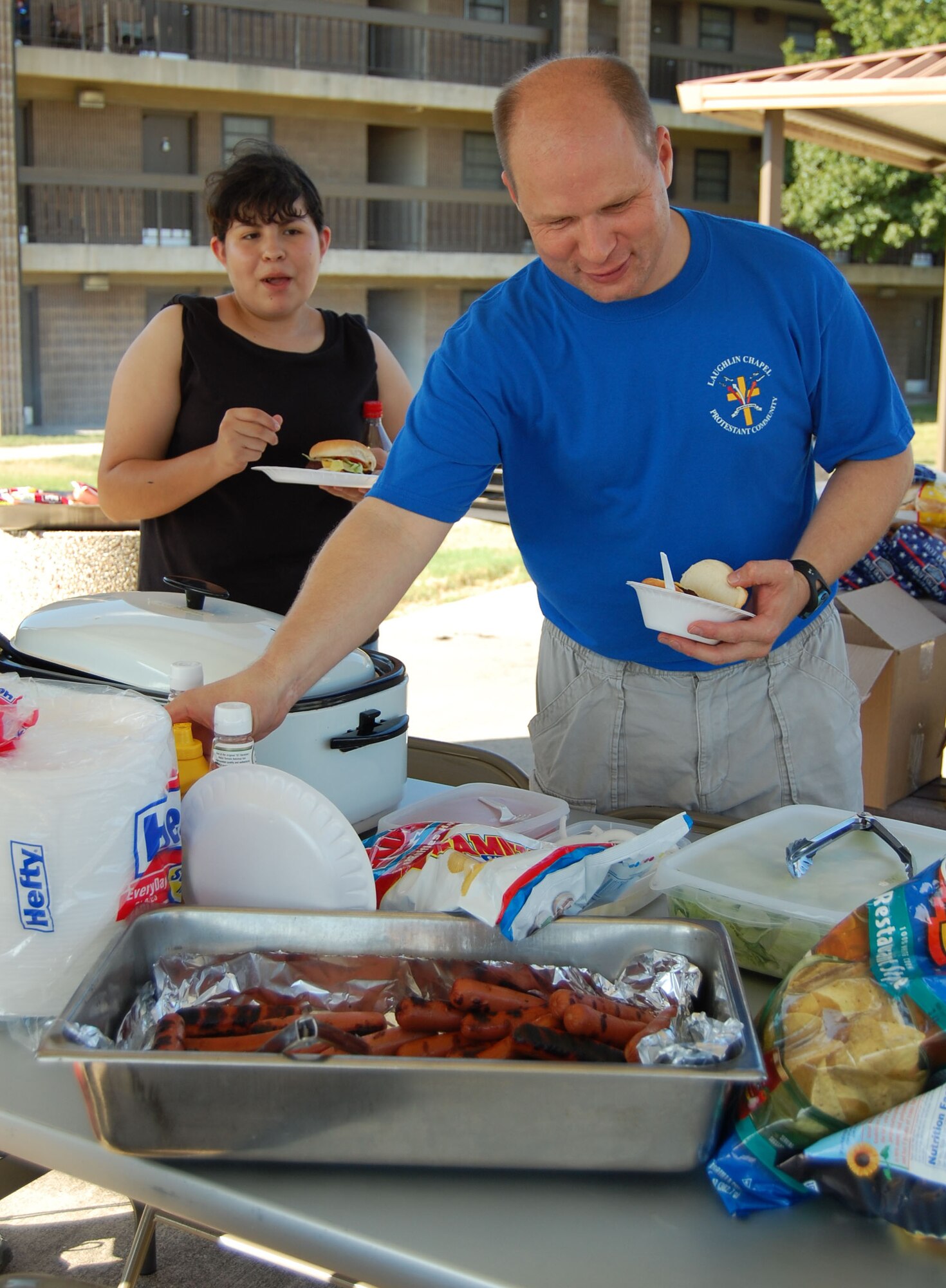 LAUGHLIN AIR FORCE BASE, Texas -- Chaplain (Capt.) Shannon Workman, helps prepare food at the "Cookout Delux" Friday. Chaplain Workman held this social gathering for all single Airmen living in the dorms here. There was an abundance of food and people in order for Airmen to stick around to get better acquainted and take advantage of the nice weather. 

