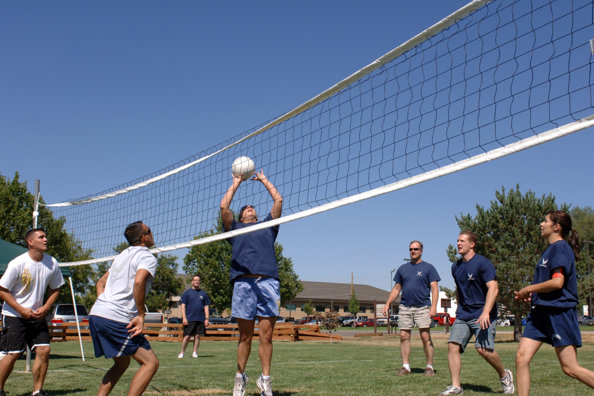 Members of the 75th Air Base Wing Public Affairs office square off against members from the 649th Munitions Squadron in volleyball during the Air Force 60th Birthday Bash Sports Day. Other competitive activities were included such as horse shoes, tug o' war, table tennis, arm wrestling and disc golf.