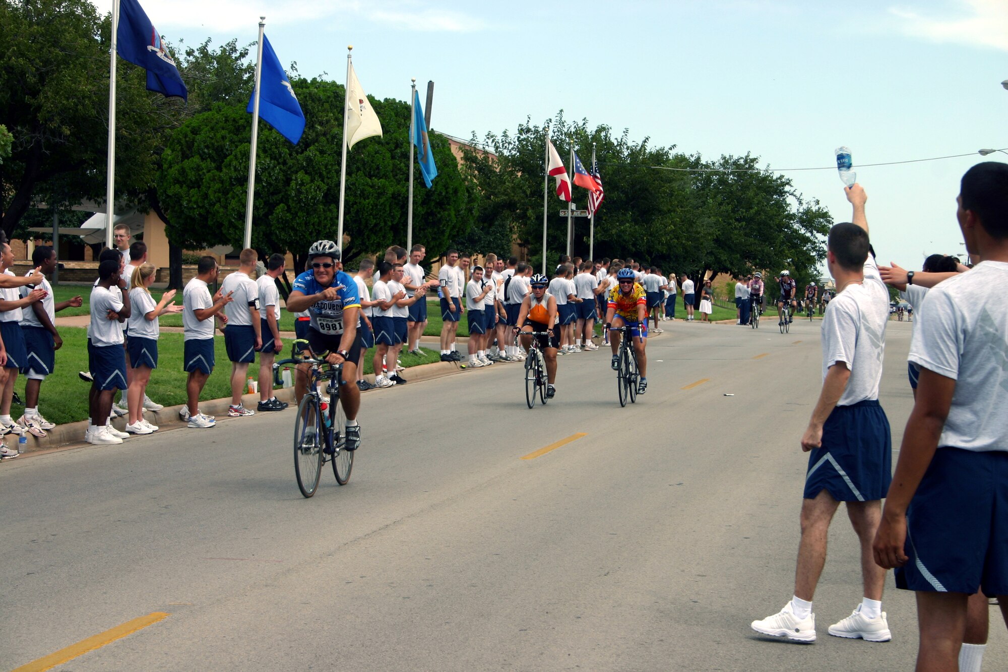 Airmen in Training show their support for the bikers participating in the Hotter'N Hell marathon Aug. 25.  The bikers rode through Sheppard as part of their route. (U.S. Air Force photo/Staff Sgt. Tonnette Thompson)