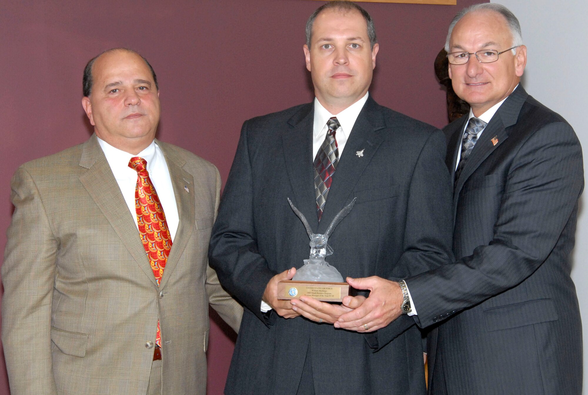Mr. Anthony Martoccia, director for the Office of Small Business Programs and Dr. James Finley, the deputy under Secretary of Defense for Acquisition and Technology pose with Small Business Program Manager of the Year Winner, Mr. William G. Machingo Aug. 22 in Washington, D.C. (U.S. Air Force photo/Tech. Sgt. Cohen A. Young)


