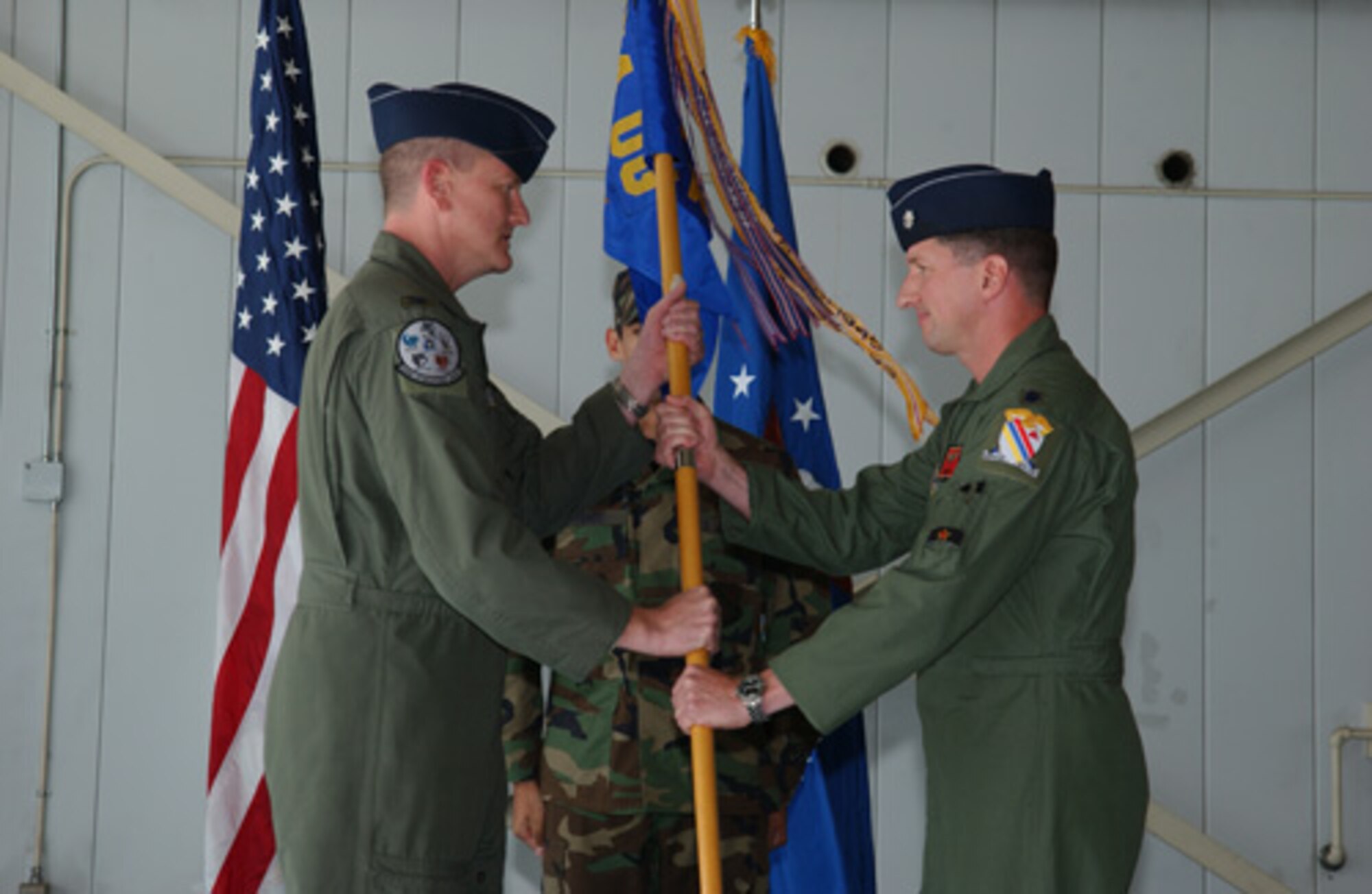 EIELSON AIR FORCE BASE, Alaska -- Col. Mark Moore, 354th Operations Group commander, passes the guidon to Lt. Col. Patrick Welch, 18th Aggressor Squadron commander, Aug. 24 at the Load Barn. This assumption of command signifies the official activation of the 18th Aggressor Squadron. (U.S. Air Force Photo by Airman 1st Class Jonathan Snyder)