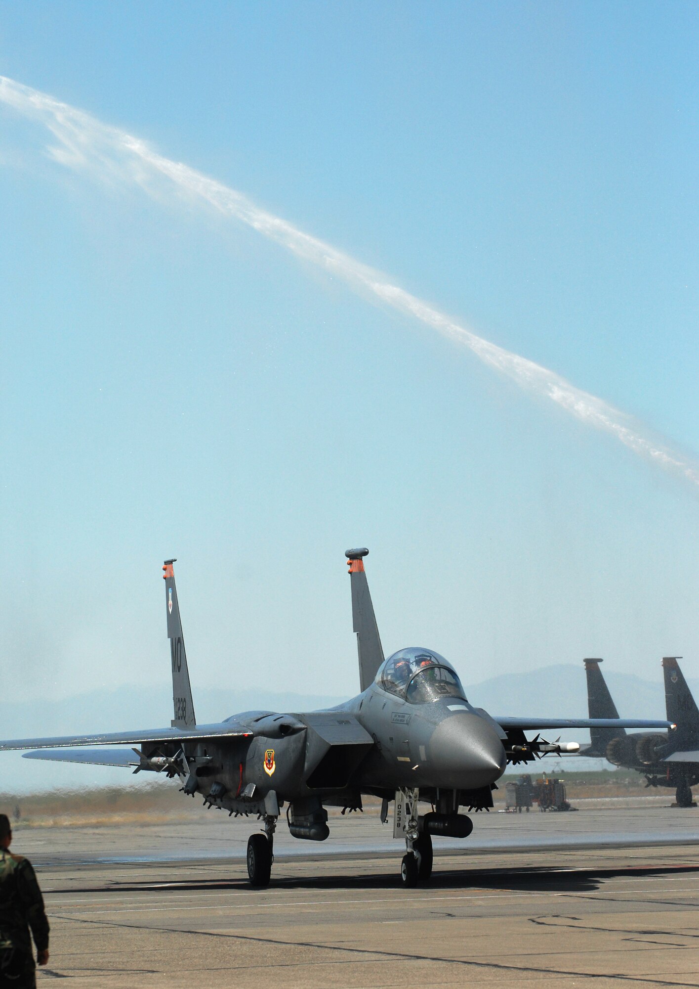 MOUNTAIN HOME AIR FORCE BASE, Idaho -- Col. Tony Rock, the 366th Fighter Wing’s outgoing commander, and Lt. Col. Kevin Brown, wing chief of plans, programs and assessments, taxi their F-15 under a stream of water after Colonel Rock’s final flight in the F-15E here Aug. 24. Recently selected to for promotion to brigadier general, Colonel Rock leaves here in September to serve as the deputy director for operations for North American Aerospace Defense Command and U.S. Northern Command at Peterson Air Force Base, Colo. (U.S. Air Force photo/Airman 1st Class Ryan Crane)