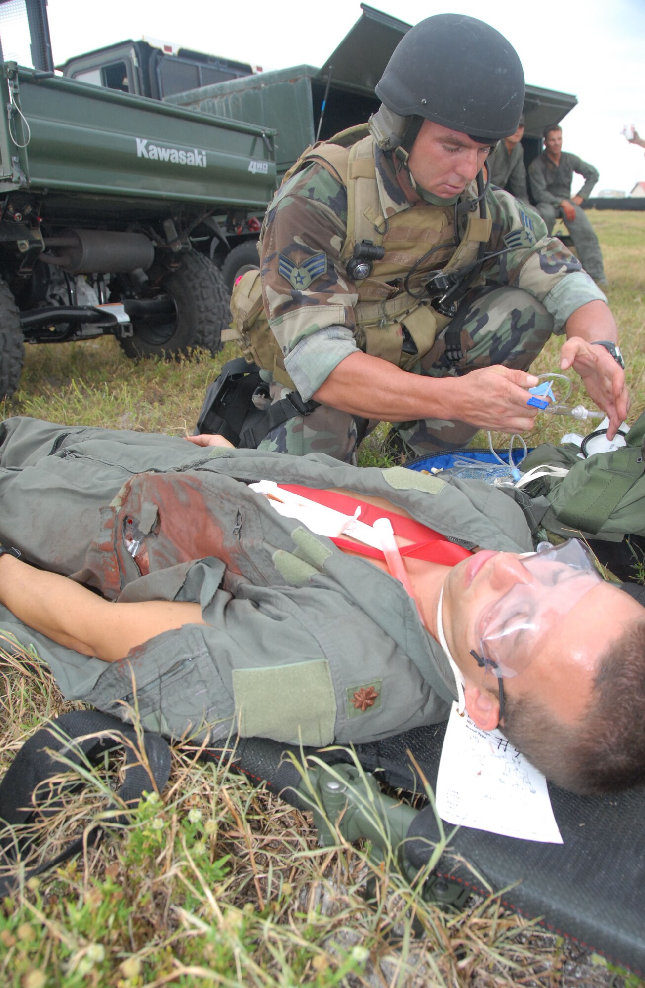 Air Force Reservist Senior Airman Josh Frost, 308th Resuce Squadron pararescueman, prepares to give medical treatment to a casualty, Capt. Gabriel Hensley, a 308th RQS combat rescue officer, during training at Patrick Air Force Base, Fla. The PJs were performing casualty assessment and extraction from a simulated improvised explosive device, or IED, attack on a convoy of vehicles Aug. 23. (Air Force photo/Master Sgt. Chance C. Babin) 
