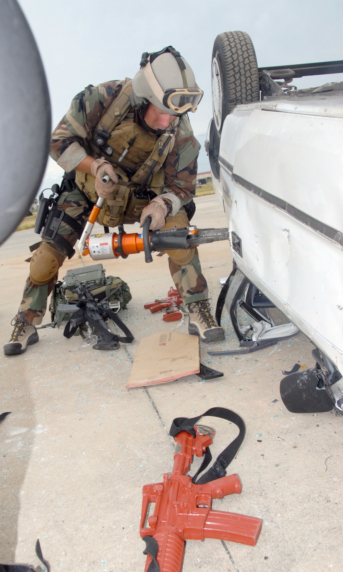 Air Force Reservist Master Sgt. James "JJ" Johnston, 308th Rescue Squadron, pararescueman. uses the jaws of life to extract casulaties from a overturned vehicle during training at Patrick Air Force Base, Fla. The PJs were performing casualty assessment and extraction from a simulated improvised explosive device, or IED, attack on a convoy of vehicles Aug. 23. (Air Force photo/Master Sgt. Chance C. Babin) 