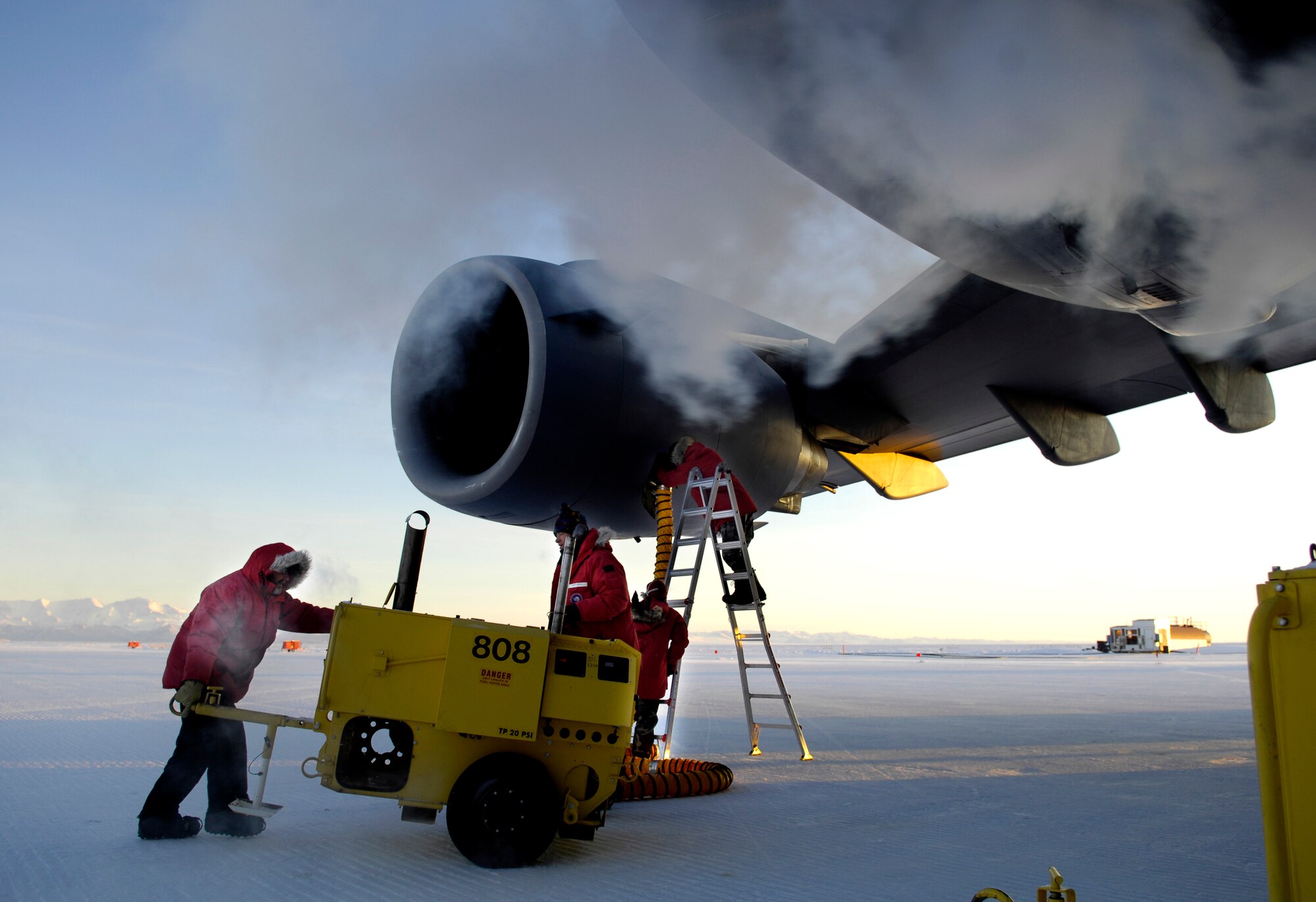 Maintainers attach heater hoses to the engines of a C-17 Globemaster III Aug. 25, 2007 at Pegasus White Ice Runway, Antarctica during an Operation Deep Freeze winter fly-in mission. Because of the extreme temperatures, heaters are used on the aircraft to prevent maintenance problems and keep it functioning properly upon engine start-up. A C-17 and 31 Airmen from McChord Air Force Base, Wash. are conducting the annual winter fly-in augmentation of scientist, support personnel, food and equipment for the U.S. Antarctic Program at McMurdo Station, Antarctica. WinFly is the opening of the first flights to McMurdo station, which closed for the austral winter in Feb. (U.S. Air Force photo/Tech. Sgt. Shane A. Cuomo)