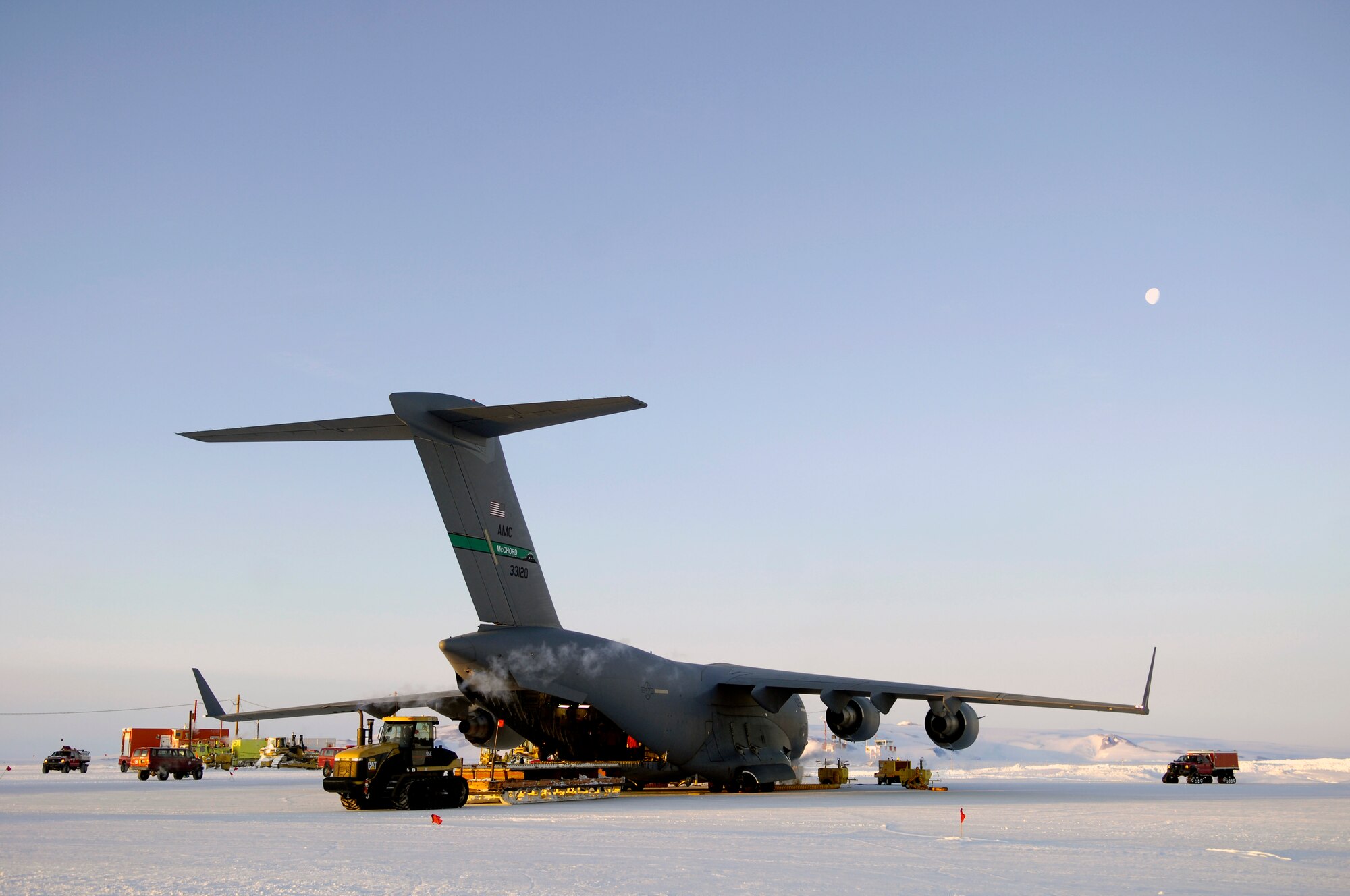 A C-17 Globemaster III is unloaded at Pegasus White Ice Runway, Antarctica Aug. 25, 2007 during an Operation Deep Freeze winter fly-in mission. A C-17 and 31 Airmen from McChord Air Force Base, Wash. are conducting the annual winter fly-in augmentation of scientist, support personnel, food and equipment for the U.S. Antarctic Program at McMurdo Station, Antarctica. WinFly is the opening of the first flights to McMurdo station, which closed for the austral winter in Feb. (U.S. Air Force photo/Tech. Sgt. Shane A. Cuomo)