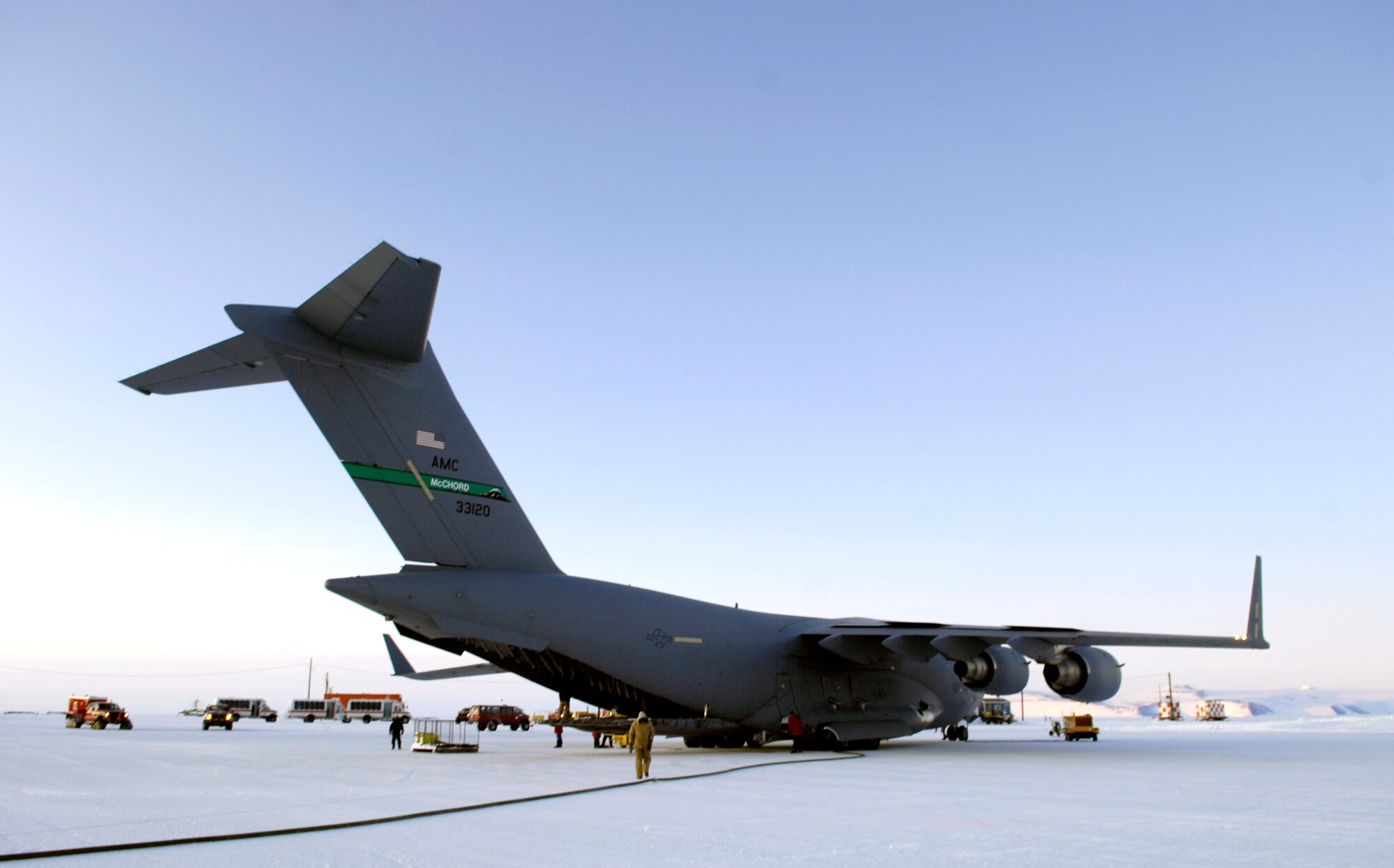 A C-17 Globemaster III downloads cargo and receives fuel at Pegasus White Ice Runway, Antarctica Aug. 25, 2007 during an Operation Deep Freeze winter fly-in mission. A C-17 and 31 Airmen from McChord Air Force Base, Wash. are conducting the annual winter fly-in augmentation of scientist, support personnel, food and equipment for the U.S. Antarctic Program at McMurdo Station, Antarctica. WinFly is the opening of the first flights to McMurdo station, which closed for the austral winter in Feb. (U.S. Air Force photo/Tech. Sgt. Shane A. Cuomo)