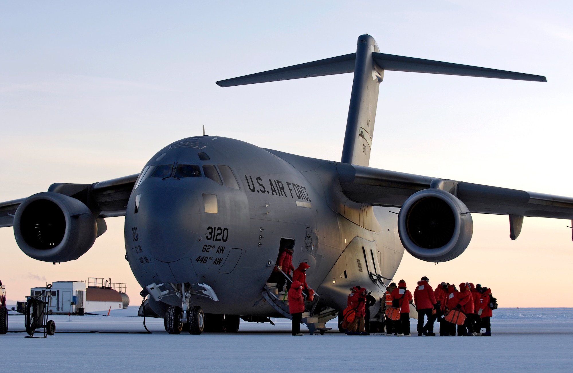 United States Antarctic Program participants get off a C-17 Globemaster III at Pegasus White Ice Runway, Antarctica Aug. 25, 2007 during an Operation Deep Freeze winter fly-in mission. A C-17 and 31 Airmen from McChord Air Force Base, Wash. are conducting the annual winter fly-in augmentation of scientist, support personnel, food and equipment for the U.S. Antarctic Program at McMurdo Station, Antarctica. WinFly is the opening of the first flights to McMurdo station, which closed for the austral winter in Feb. (U.S. Air Force photo/Tech. Sgt. Shane A. Cuomo)

