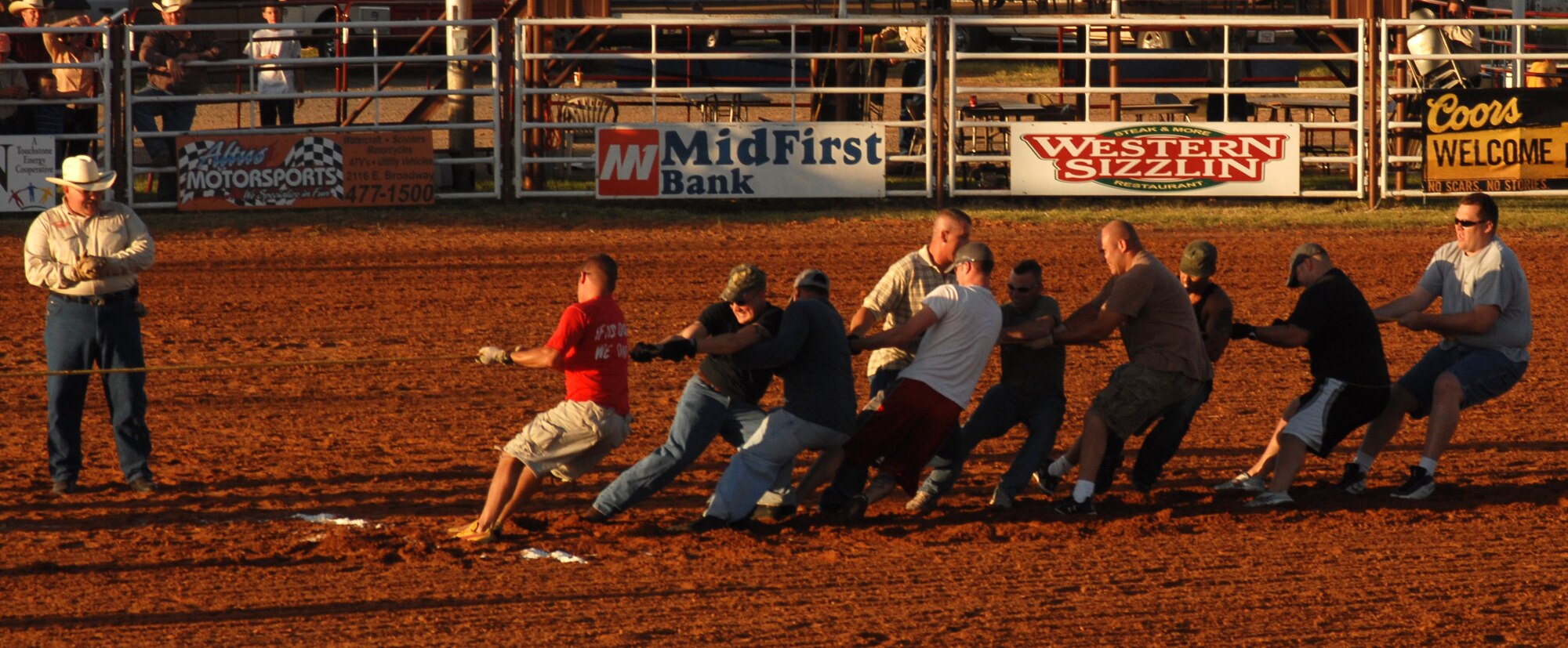 Airmen from the 97th Security Forces pull their Army Reserve opponents over their threshold to clinch a tug-o-war victory at the Great Plains Stampede Rodeo. (U.S. Air Force photo/Airman 1st Class Rebecca Talley)