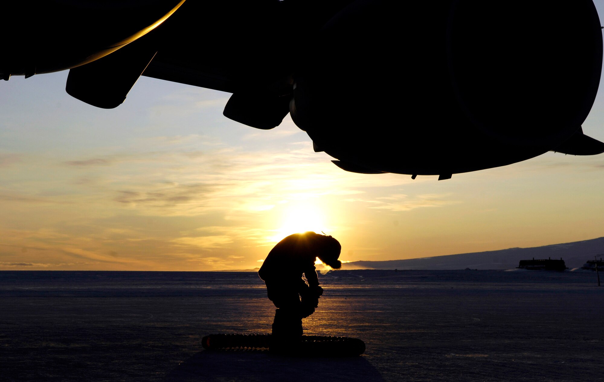 Senior Airman Christian Recene collapses a heater hose that was used to keep the engines of a C-17 Globemaster III warm during an Operation Deep Freeze winter fly-in mission Aug. 25 at Pegasus White Ice Runway, Antarctica. Because of the extreme temperatures, heaters are used on the aircraft to prevent maintenance problems and keep it functioning properly upon engine start-up. A C-17 and 31 Airmen from McChord Air Force Base, Wash., conducted the annual winter fly-in augmentation of scientists, support staff, food and equipment for the U.S. Antarctic Program at McMurdo Station, Antarctica. (U.S. Air Force photo/Tech. Sgt. Shane A. Cuomo) 
