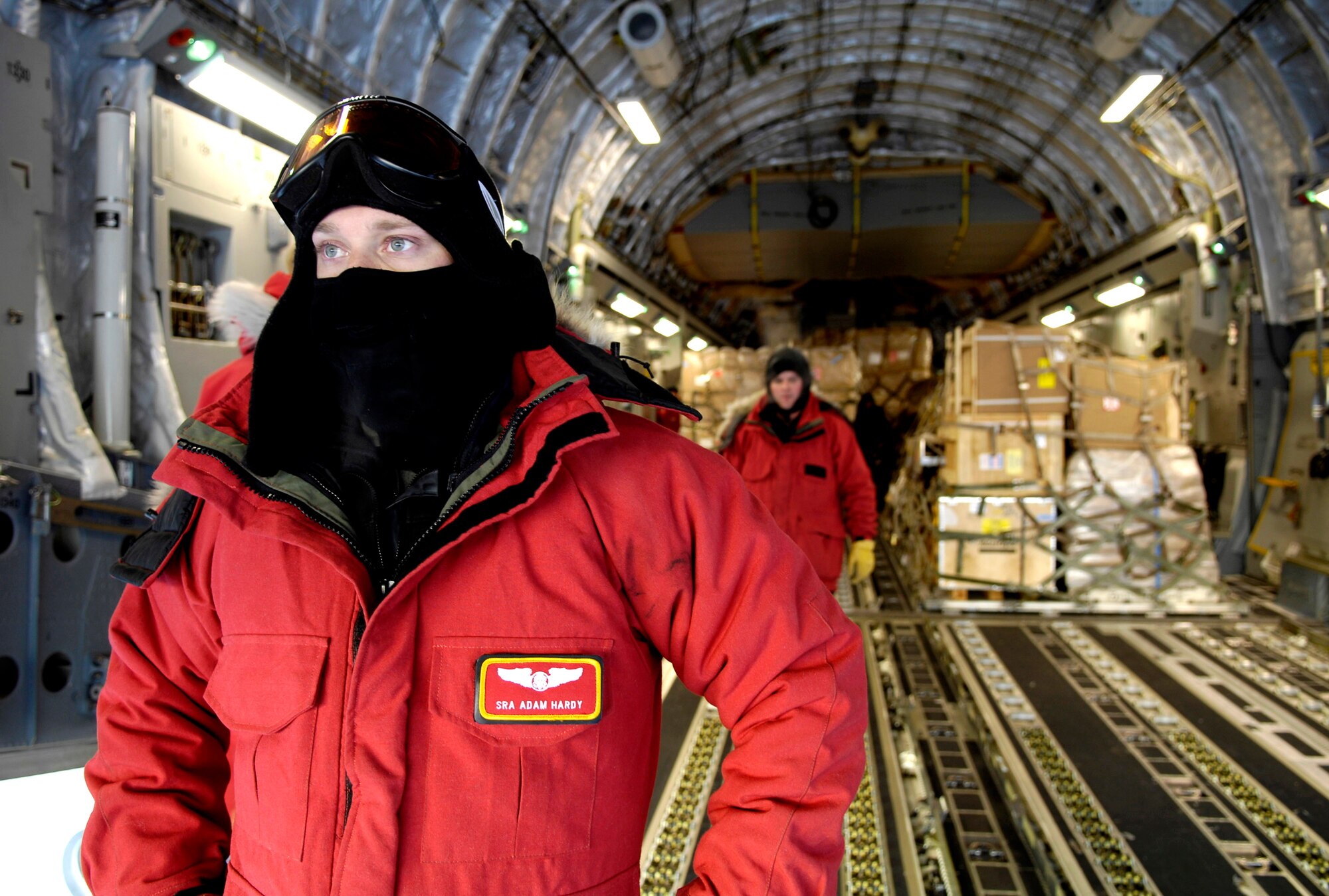 Senior Airman Adam Hardy waits to marshal a forklift to the back of his C-17 Globemaster III during an Operation Deep Freeze winter fly-in mission Aug. 25 at Pegasus White Ice Runway, Antarctica. A C-17 and 31 Airmen from McChord Air Force Base, Wash., conducted the annual winter fly-in augmentation of scientists, support staff, food and equipment for the U.S. Antarctic Program at McMurdo Station, Antarctica. (U.S. Air Force photo/Tech. Sgt. Shane A. Cuomo) 
