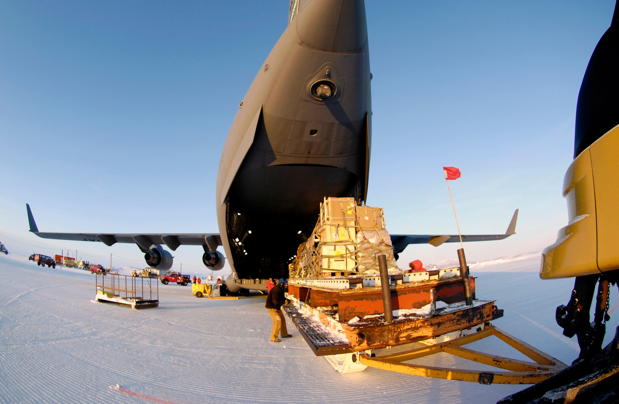 A pallet sled is used to unload cargo from a C-17 Globemaster III during an Operation Deep Freeze winter fly-in mission Aug. 25 at Pegasus White Ice Runway, Antarctica. A C-17 and 31 Airmen from McChord Air Force Base, Wash., conducted the annual winter fly-in augmentation of scientists, support staff, food and equipment for the U.S. Antarctic Program at McMurdo Station, Antarctica. (U.S. Air Force photo/Tech. Sgt. Shane A. Cuomo) 
