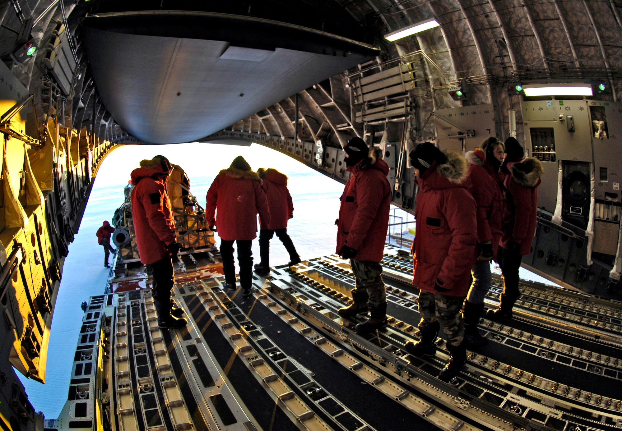 Loadmasters unload cargo from a C-17 Globemaster III during an Operation Deep Freeze winter fly-in mission Aug. 25 at Pegasus White Ice Runway, Antarctica. A C-17 and 31 Airmen from McChord Air Force Base, Wash., conducted the annual winter fly-in augmentation of scientists, support staff, food and equipment for the U.S. Antarctic Program at McMurdo Station, Antarctica. (U.S. Air Force photo/Tech. Sgt. Shane A. Cuomo) 