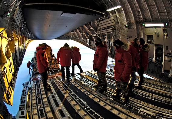 Loadmasters unload cargo from a C-17 Globemaster III during an Operation Deep Freeze winter fly-in mission Aug. 25 at Pegasus White Ice Runway, Antarctica. A C-17 and 31 Airmen from McChord Air Force Base, Wash., conducted the annual winter fly-in augmentation of scientists, support staff, food and equipment for the U.S. Antarctic Program at McMurdo Station, Antarctica. (U.S. Air Force photo/Tech. Sgt. Shane A. Cuomo) 