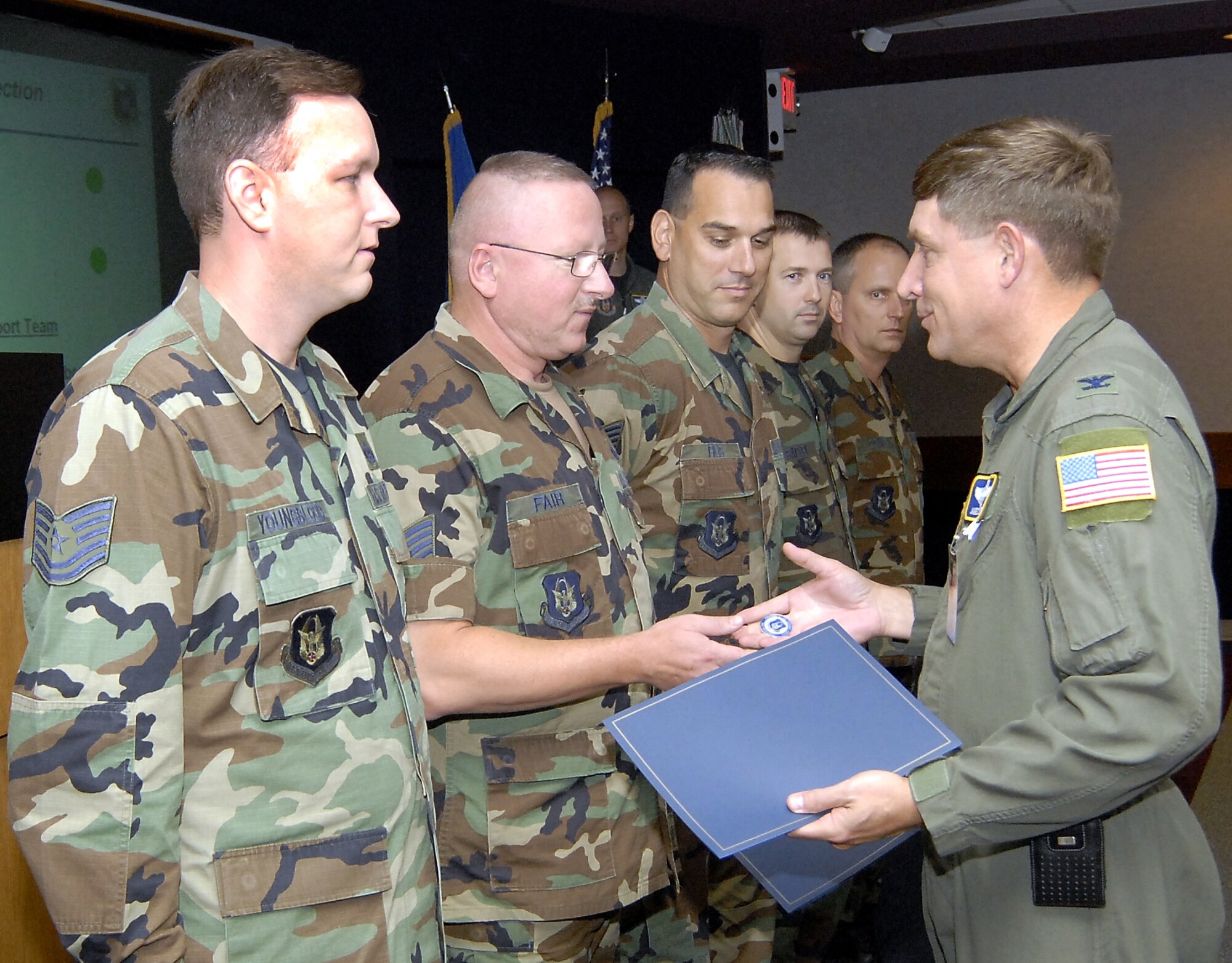 Recognized as top performers during the August Unit Compliance Inspection, the 303rd Fighter Squadron Life Support team of Tech. Sgts. William Youngblood, Michael Fair, Pete Filis, Master Sgt. Rob Safley and Senior Master Sgt. Joe O'Daniel, are each presented a recognition coin by Col. James Stewart, Air Force Reserve Command Inspector General. (US Air Force photo/Master Sgt. Bill Huntington)