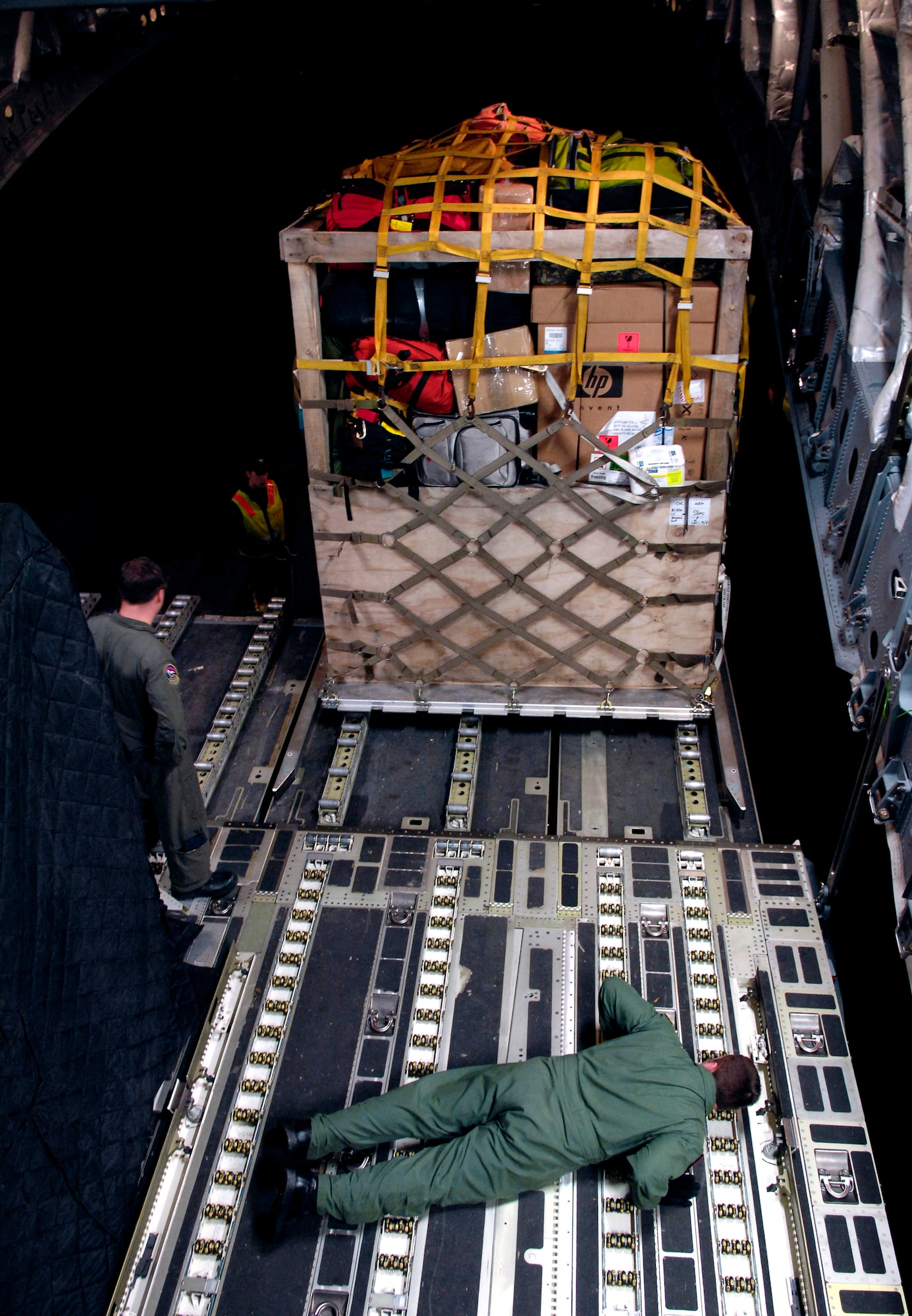 Tech. Sgt. Kris Albertson checks the clearance of a cargo pallet being loaded onto a C-17 Globemaster III during Operation Deep Freeze Aug. 25 at Christchurch, New Zealand. A C-17 and 31 Airmen from McChord Air Force Base, Wash., conducted the annual winter fly-in augmentation of scientists, support staff, food and equipment for the U.S. Antarctic Program at McMurdo Station, Antarctica. (U.S. Air Force photo/Tech. Sgt. Shane A. Cuomo) 
