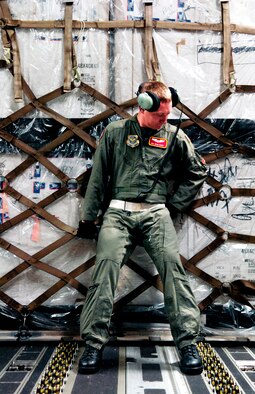Senior Airman Adam Hardy pushes a pallet into place on a C-17 Globemaster III during Operation Deep Freeze Aug. 25 at Christchurch, New Zealand. A C-17 and 31 Airmen from McChord Air Force Base, Wash. conducted the annual winter fly-in augmentation of scientists, support staff, food and equipment for the U.S. Antarctic Program at McMurdo Station, Antarctica. (U.S. Air Force photo/Tech. Sgt. Shane A. Cuomo) 
