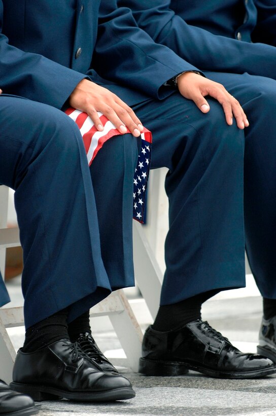 U.S. Air Force Airmen listen to speakers during a naturalization ceremony at Mount Rushmore National Memorial, S.D., Aug. 23, 2007.  Seven of the Airmen taking this last step to become citizens of the United States are from Ellsworth Air Force Base, S.D.  (U.S. Air Force photo/Staff Sgt. Michael B. Keller)