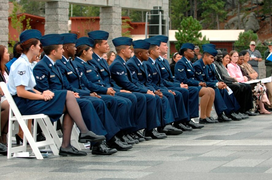 U.S. Air Force Airmen listen to speakers during a naturalization ceremony at Mount Rushmore National Memorial, S.D., Aug. 23, 2007.  Seven of the Airmen taking this last step to become citizens of the United States are from Ellsworth Air Force Base, S.D.  (U.S. Air Force photo/Staff Sgt. Michael B. Keller)