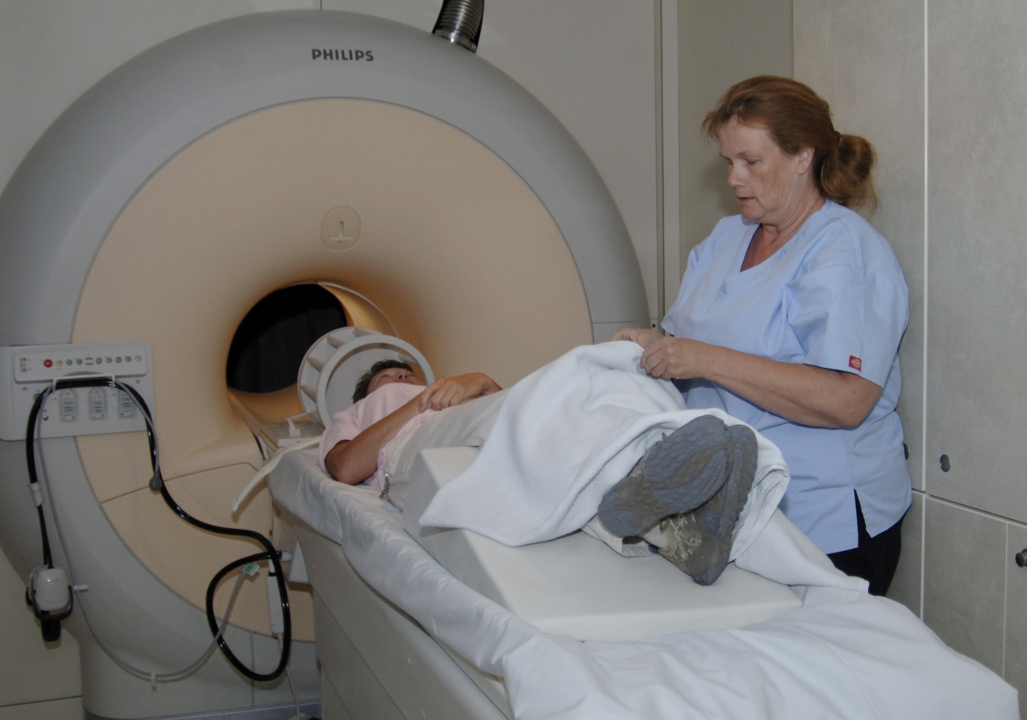 MOUNTAIN HOME AIR FORCE BASE, Idaho -- Magnetic resonance imaging machine technologist Brenda Anderson, from the MRI Center of Idaho preps Lisa Scott, Veterans Affairs medical center MRI technologist, for an MRI test Aug. 20. The VA bought the mobile MRI machine, a $2.1 million project, with money set aside by Congress as part of the National Defense Authorization Act. Congress. The act was created encourage the development of sharing initiatives between the VA and Department of Defense. The base hospital and the VA center in Boise will equally share the mobile MRI machine on a rotating schedule. (U.S. Air Force photo/ Senior Airman Megan P. Lyon)