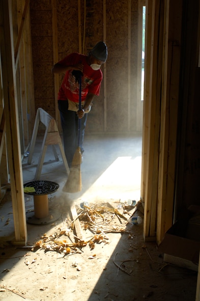 Staff Sgt. Bruchell Vaughn, 23rd Medical Group immunizations technician, sweeps leftover building materials from a Habitat for Humanity Home Aug. 15. in Valdosta Ga. before a building inspection by local city inspectors. Various squadrons from Moody Air Force Base volunteered their time during a week-long “blitz build.” (U.S. Air Force photo/Senior Airman Javier Cruz Jr)