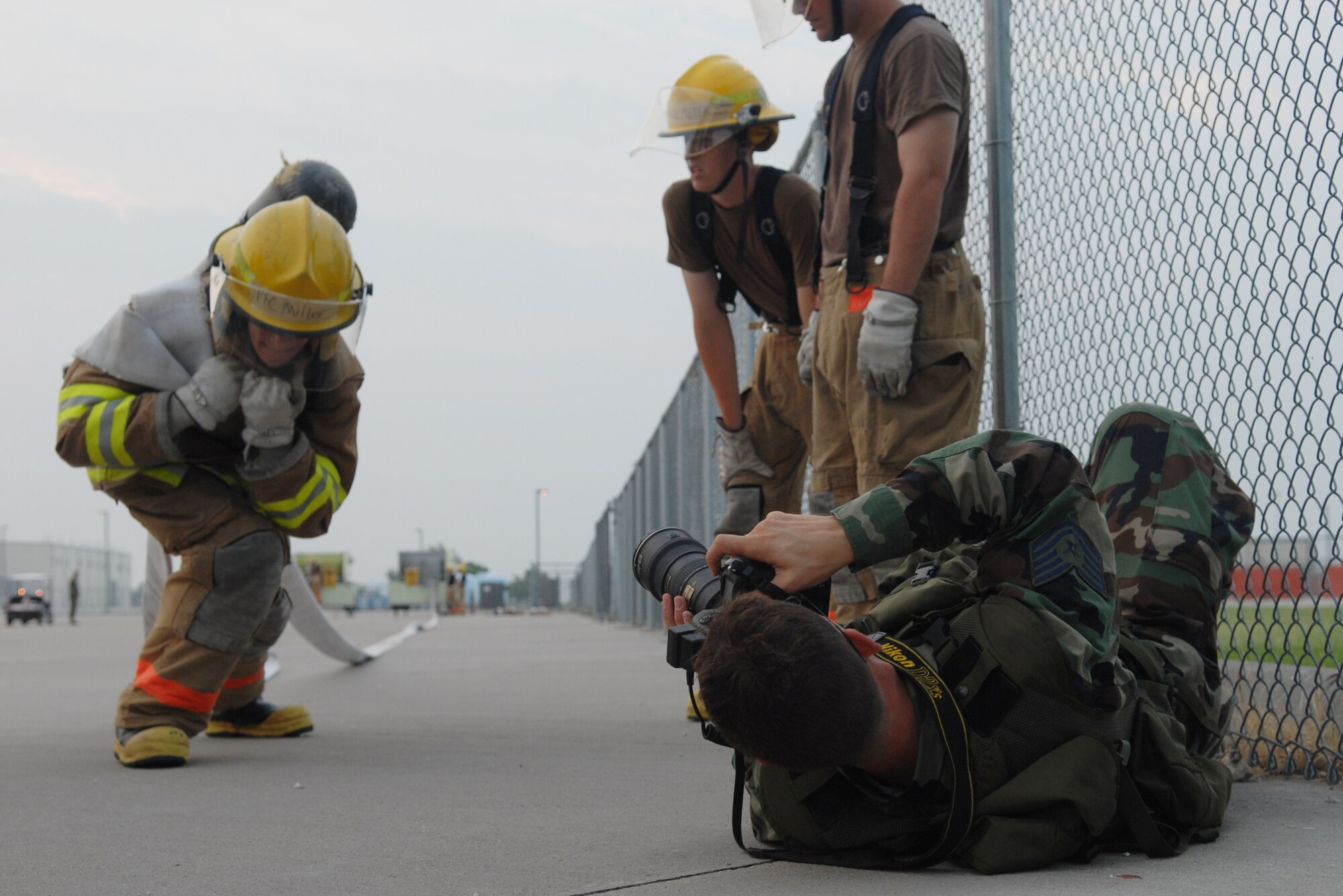 Tech. Sgt. Matthew Hannen, photographer for the Air Education and Training Command’s Torch Magazine, photographs students taking part in a fire hose evolution. Sergeant Hannen came to Goodfellow to do a story on the Louis F. Garland Department of Defense Fire Academy for an upcoming Torch Magazine issue. (U.S. Air Force photo by Airman 1st Class Kamaile Chan)